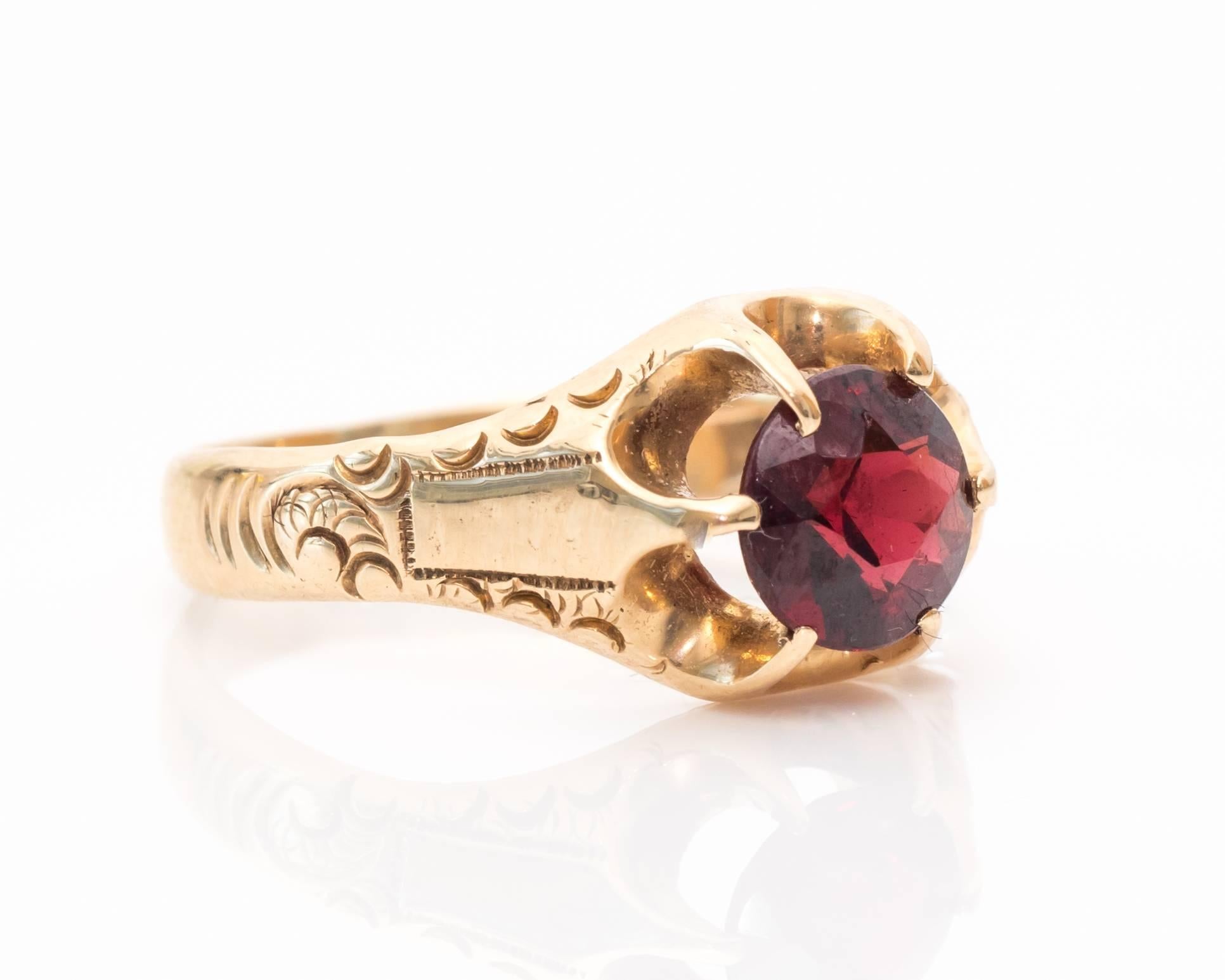Gorgeous Red-Stone (Likely Garnet but hard to test due to the unique prong-set) and Yellow Gold Cocktail Ring!
There are six prongs mounted around the ring with large U-shaped galleries between each prong. The entire gemstone is visible due to this