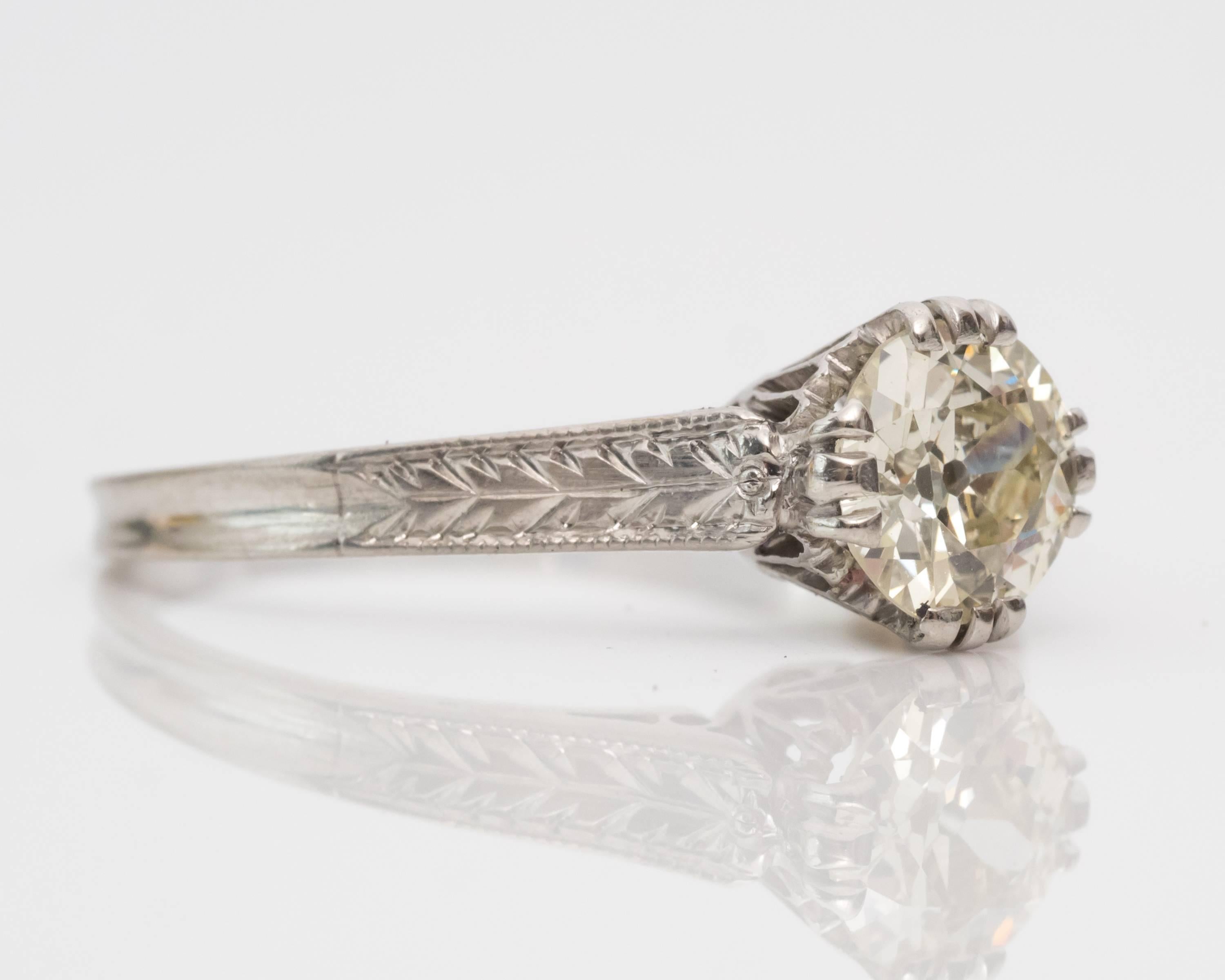 1930s GIA Certified 0.67 Carat Solitaire Diamond Platinum Engagement Ring. Lots of gorgeous intricate etchings and gallery work visible all over the ring. 

Center diamond is an Old European cut, set in a four fishtail prongs that taper to a floral