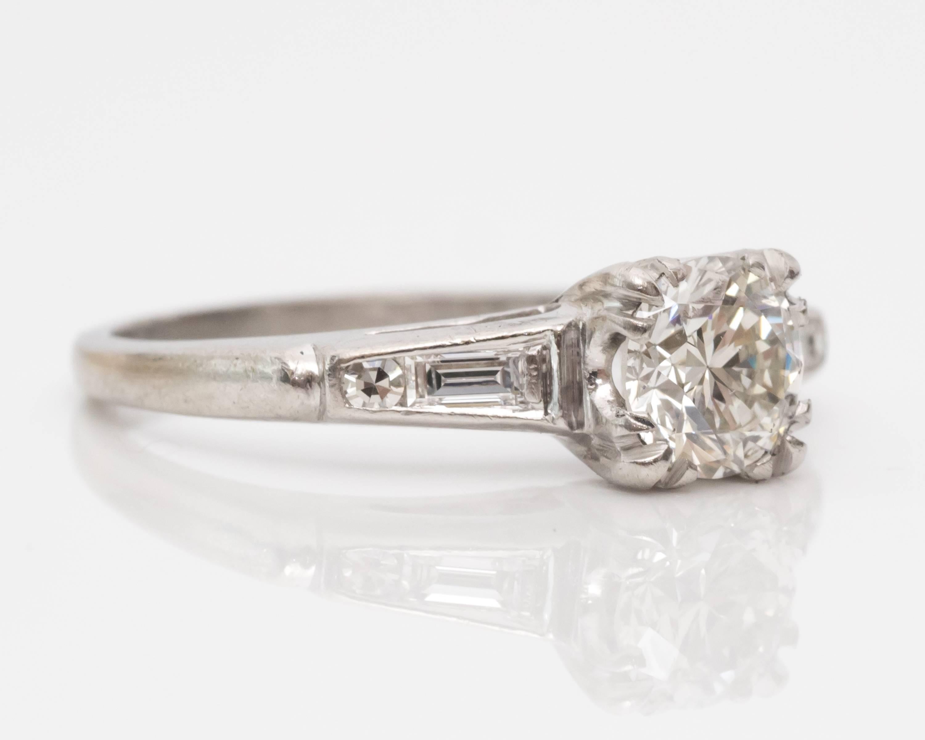 This ring embodies the bold simplicity of the 1940s, with stunning diamonds to suit its style. The center stone is a GIA certified diamond with .74 carat and an old European transitional cut. The diamond is mounted in four triple fishtail prongs.