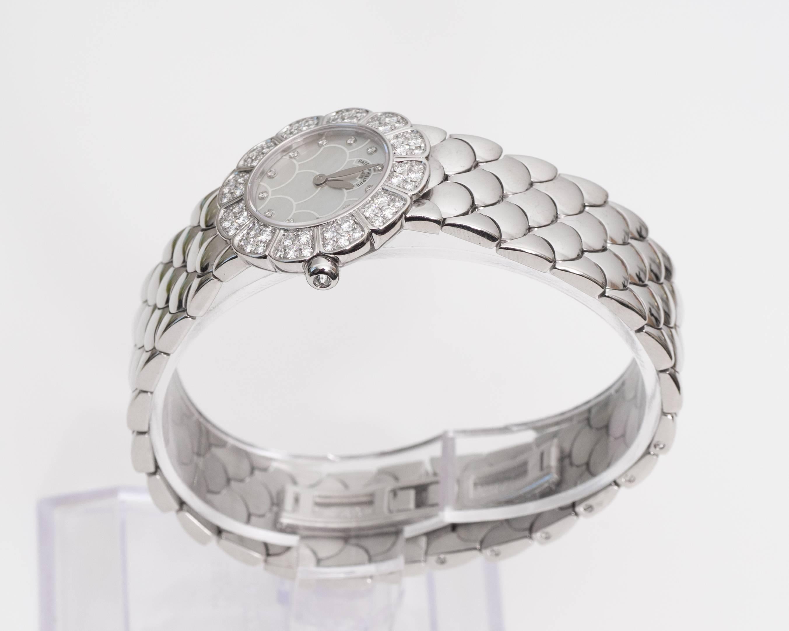 1980s
Patek Philipe
Womens Wrist Watch
18 Karat White Gold with Diamonds, 0.50 carats total
Diamonds are F color VS clarity
Fits up to 7.7 inch wrist 
Quartz Movement
Bracelet features a fish-scale link pattern
Recently Polished and Serviced, Mint