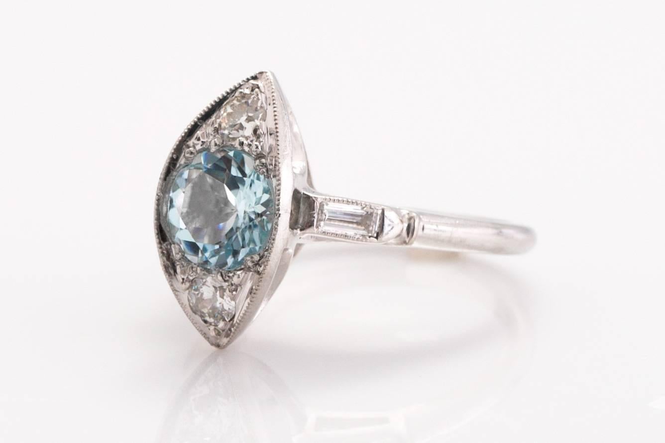 Item Details: 
Ring Size: 6.75
Metal Type: Platinum
Weight: 7.0 grams

Color Stone Details: 
Type: Natural Aquamarine 
Shape: Old European Cut Round 
Carat Weigh: 1.30 Carat
Color: Blue

Side Stone Details: 
Shape: Old European Cut &  Straight