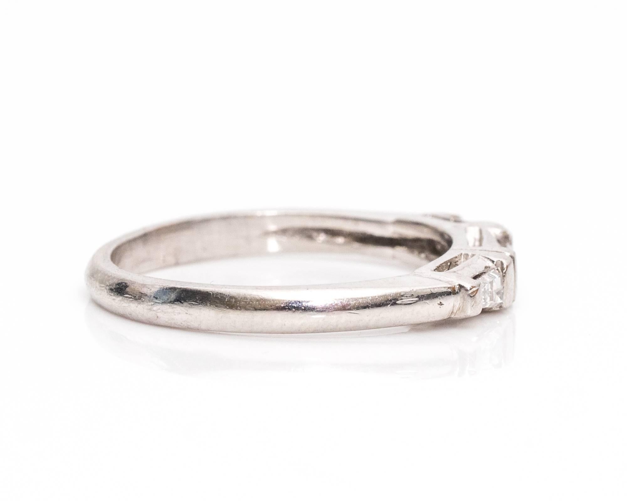 Simple Platinum 1940s Wedding Band with a Modern Look
Features Three Lovely Baguette Diamonds. The center diamond has a traditional baguette shape and the two on the shoulder are tapered in a triangular fashion. The stones are set in half bezel sets