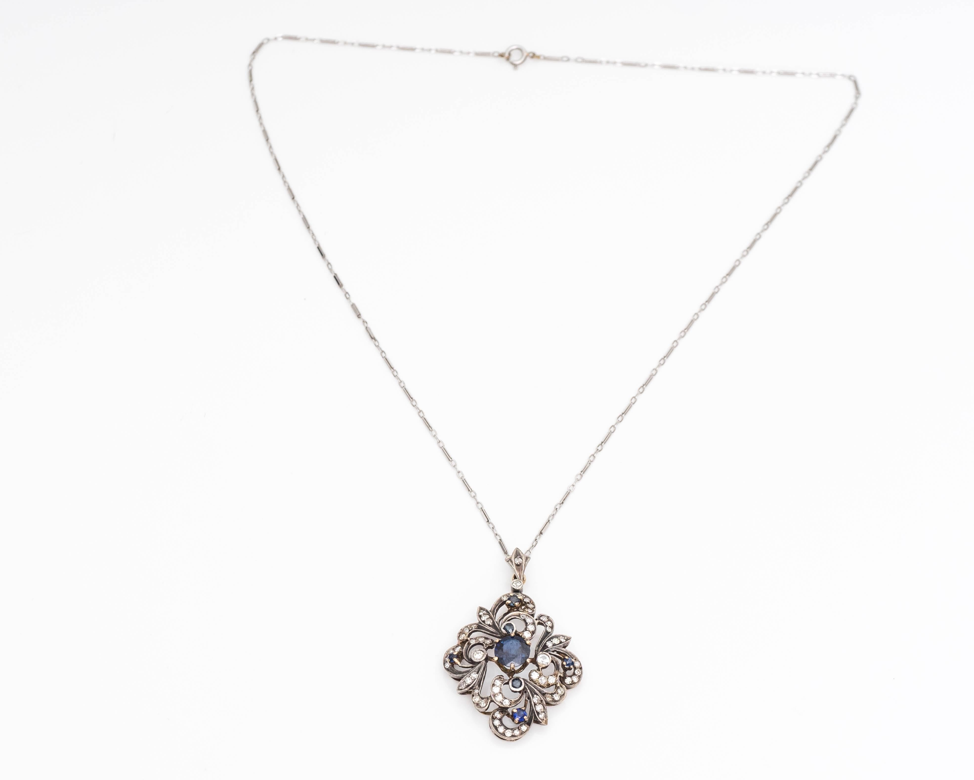 This rare collectible item comes with both a pendant and chain. The pendant can easily be removed. Features seven blue sapphires with numerous diamonds along the frame. Center sapphire stone is mounted in a six-prong frame above the rest of the