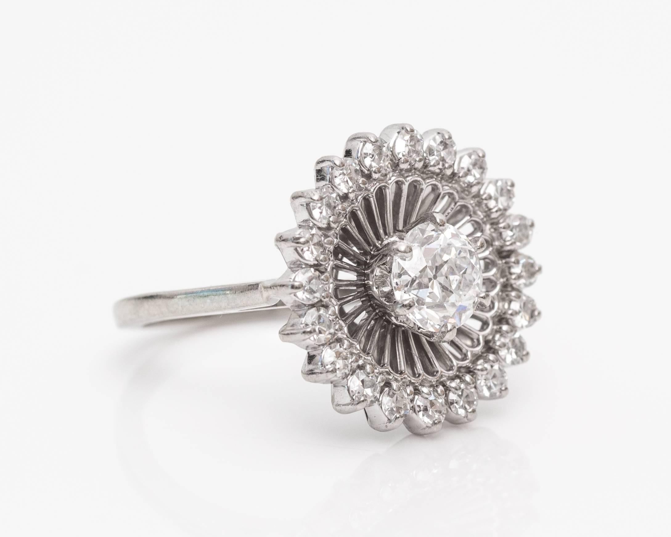 1910s Art Nouveau .70 Carat Old Mine Diamond Platinum Halo Cocktail Ring features Traditional white-on-white look with a large old mine diamond in the middle. This is mounted in a six-prong with a fan-like frame extending out at every angle to an