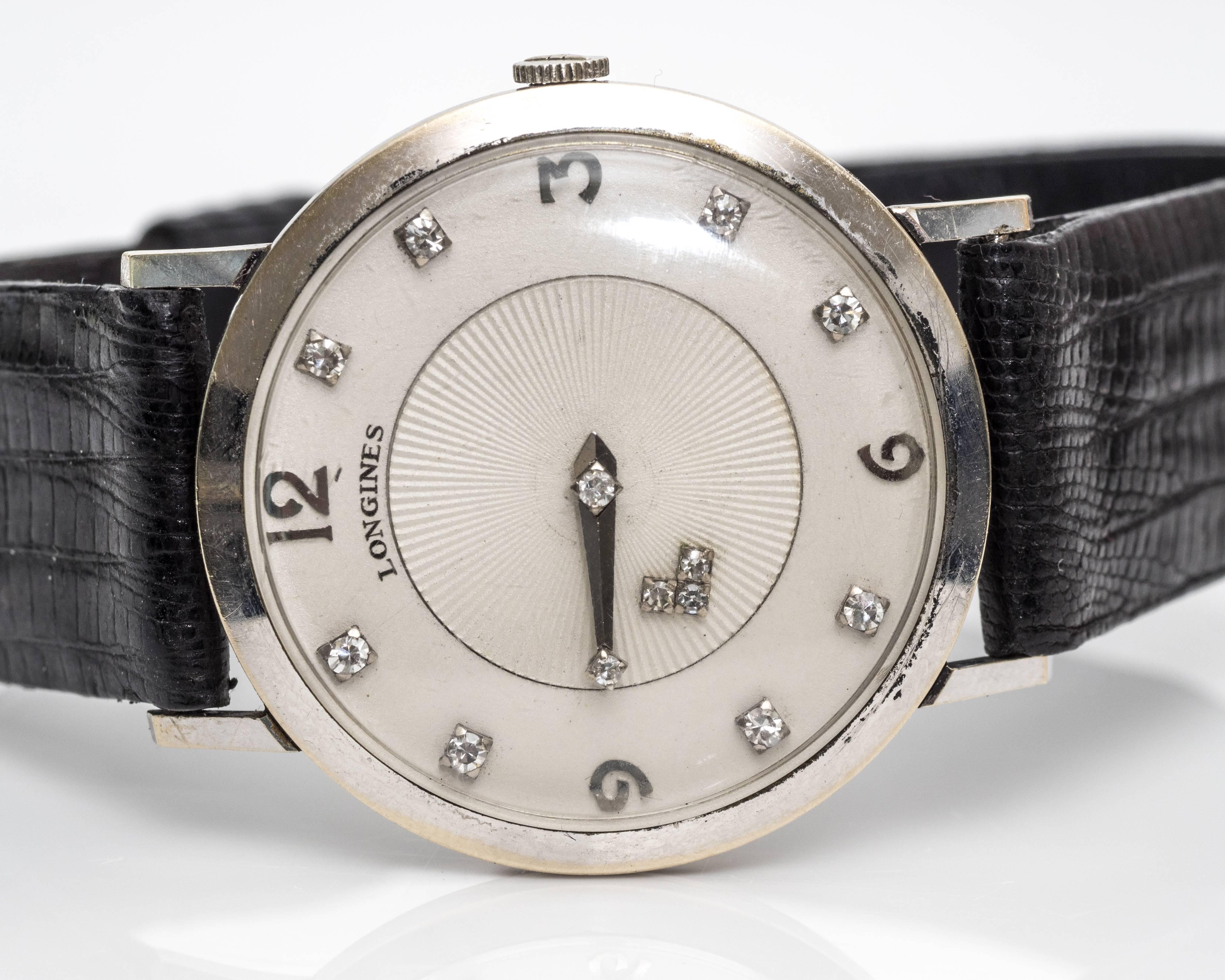 Longines 1950s 14 Karat White Gold and Diamond Mystery Wristwatch
Unisex
Embodies Simple Sophistication 
Face of Watch crafted in 14 Karat White Gold 
Features 13 Diamonds - eight of which are represented as hour markers. Hour marks 3, 6, 9 and 12