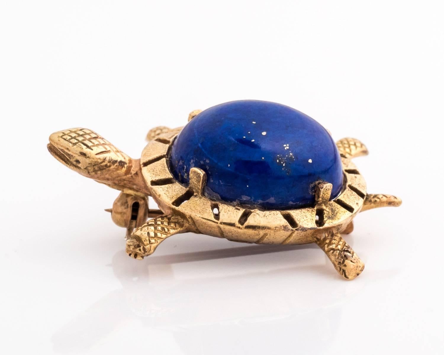 1970s Vintage Blue Lapis Cabochon and 14 Karat Yellow Gold Sea Turtle Brooch. Features a 4-prong set oval Lapis cabochon and hand etched carvings on the head, legs, tail and shell border. The lapis has a very thin crack on the right side and