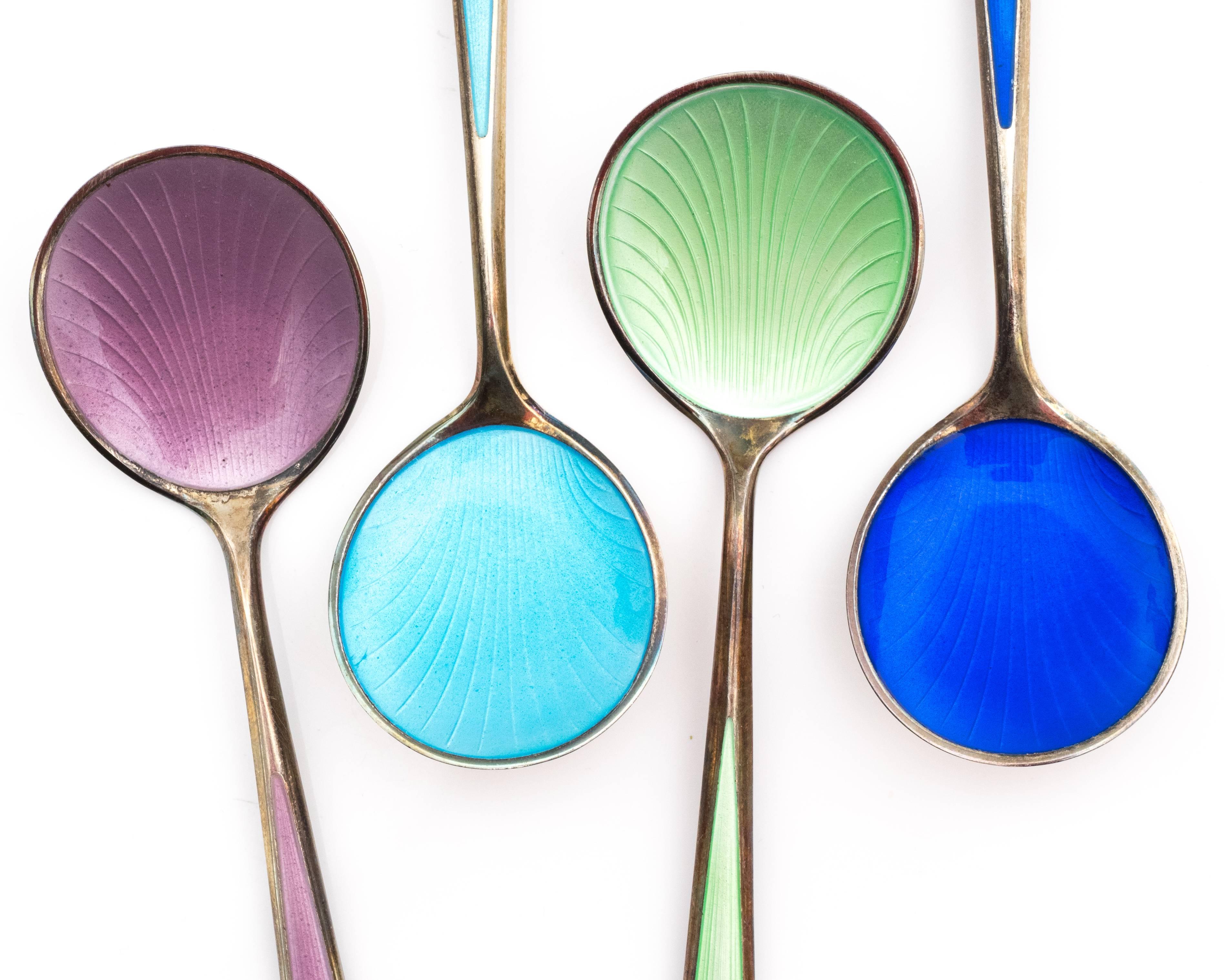 This 1930s teaspoon set comes with 8 teaspoons. All the spoons vary in pastel and deep hues with a seashell pattern embedded in the enamel. The sterling silver has not been polished recently, but could be for a cleaner look. Request complementary
