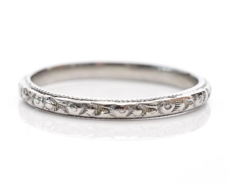1930s Art Deco Handmade Etched 18 Karat White Gold Wedding Band. This beautiful hand-etched band remains in lovely condition. The elegant ring will look great next to any engagement ring. All along the 18k white gold frame is a pattern alternating