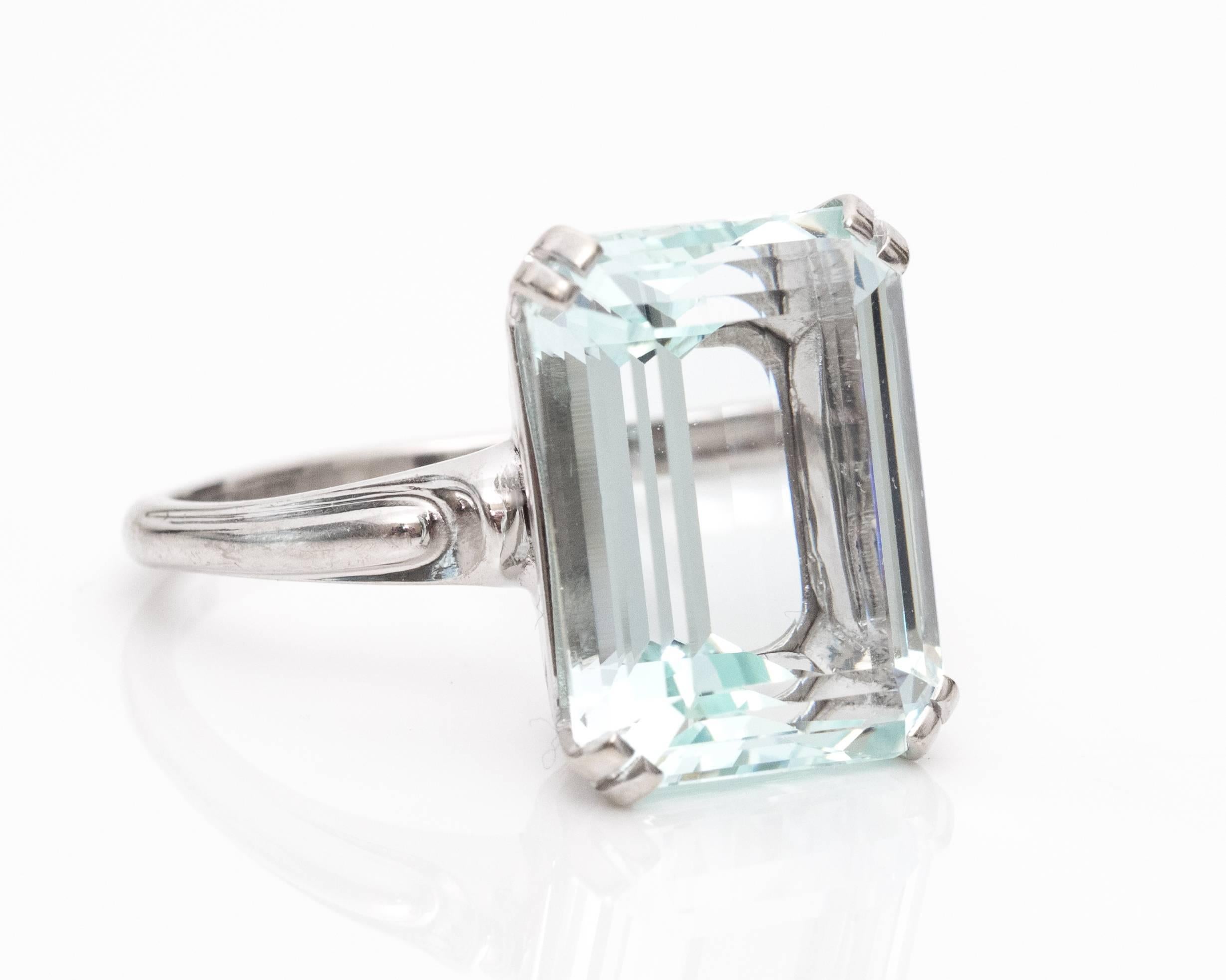10 Carat Light Blue Aquamarine Ring
14 Karat White Gold Mounting with Four Double Prongs 
Aquamarine is an Emerald Cut Stone
Ornate Appearance
Set high, similar to a cathedral high mount setting

Fits Ring size 9.75, and can be resized with ease.