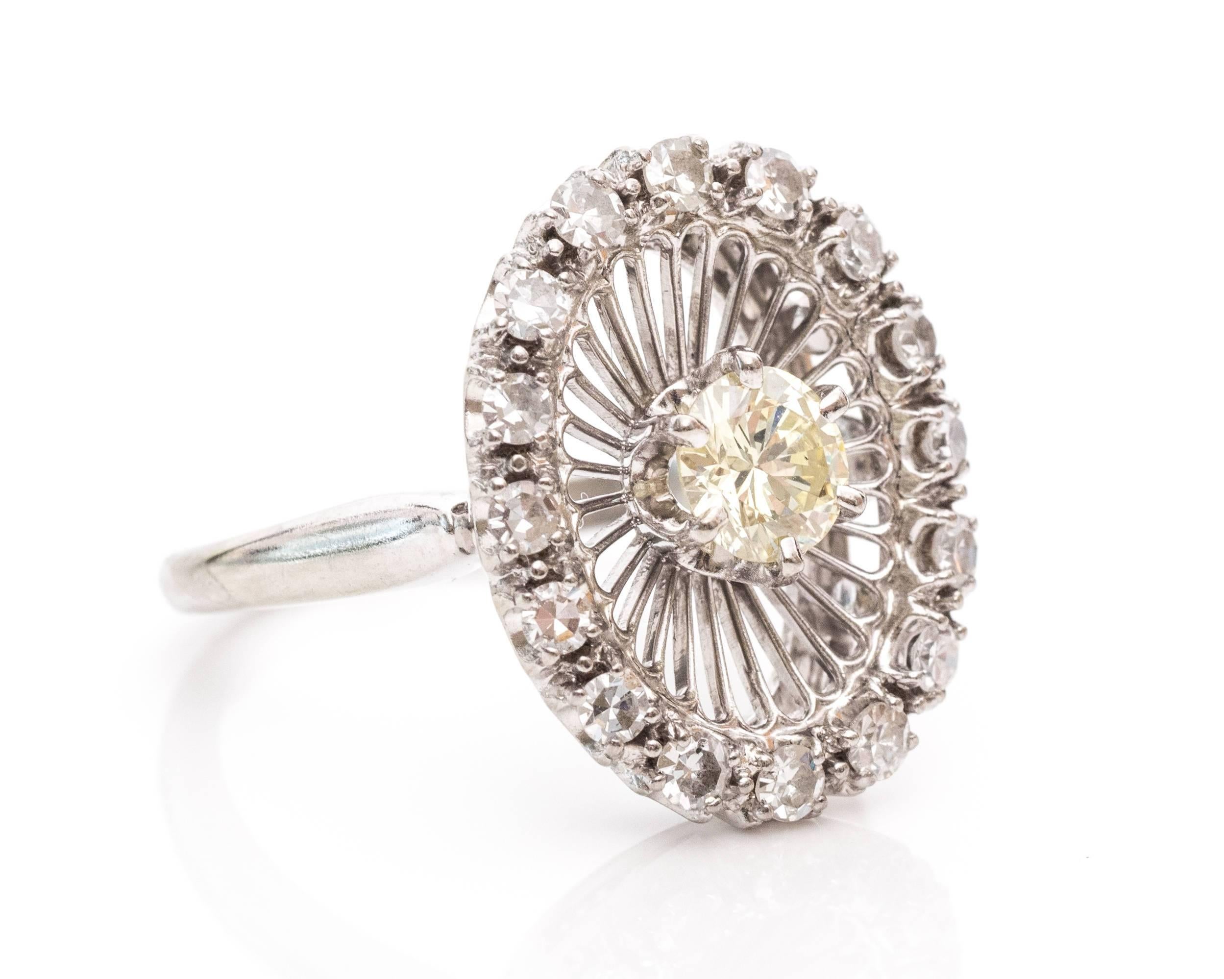 A lavish ring for someone who wants to dazzle! This JABEL jeweler ring was made in 1967. The center Old European fancy canary yellow diamond adds a subtle splash of color to this white-on-white ring. The stone is set in a six-prong frame with rows