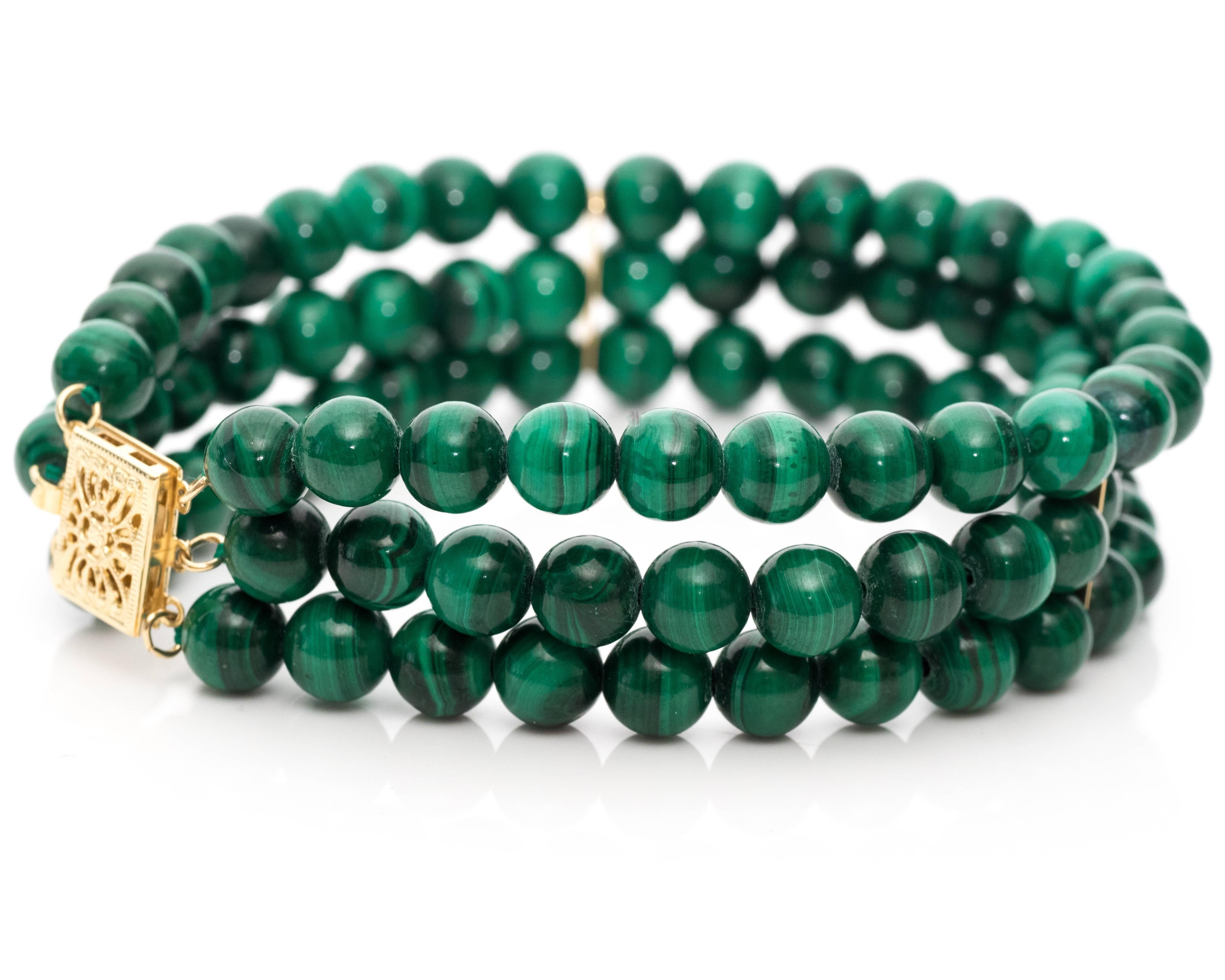 Gorgeous Hues of Emerald Green Malachite Beads Craft this Stunning Bracelet
Clasp is 14 Karat Yellow Gold with. Features a Clip for security when worn. It has beautiful filigree mesh like design on the clasp. 

1950s
3 Rows of Malachite Beads all