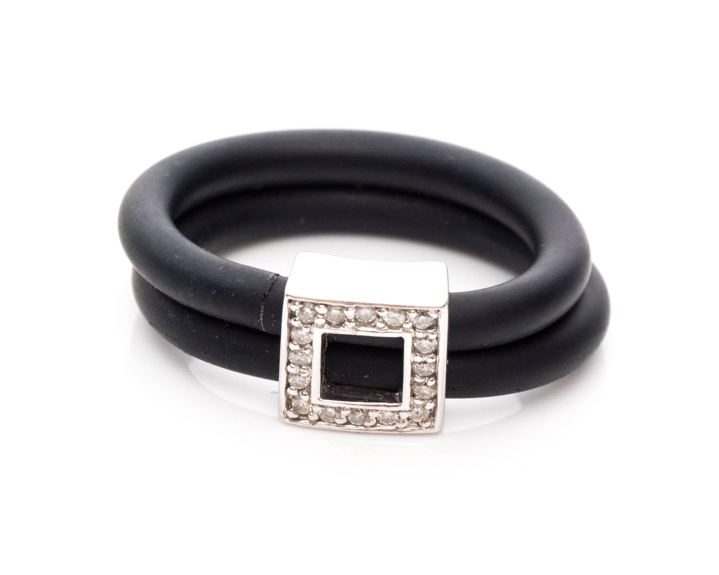 This is a black rubber belt buckle shaped ring with an accent of white gold and diamonds on the buckle frame. This Italian made ring will make a great accessory for everyday wear. The diamonds are inlayed in a white gold frame with a cutout to make