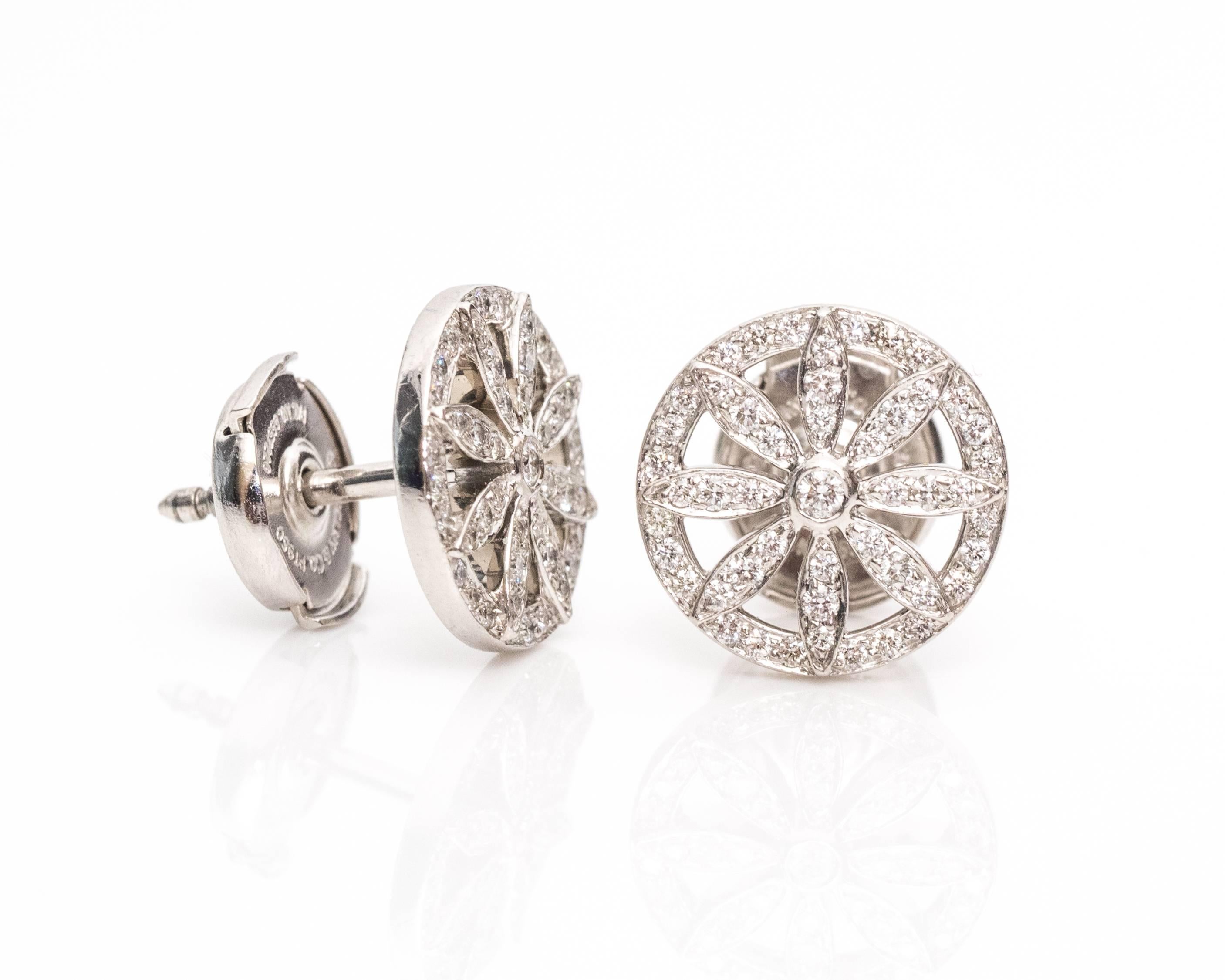 Tiffany & Co. .40 Carat Diamond and Platinum Stud Earrings. The center of each piece has a star/floral shape embedded with round brilliant diamonds. The diamonds total to .40 carats with F color and VS clarity. The studs are made of platinum