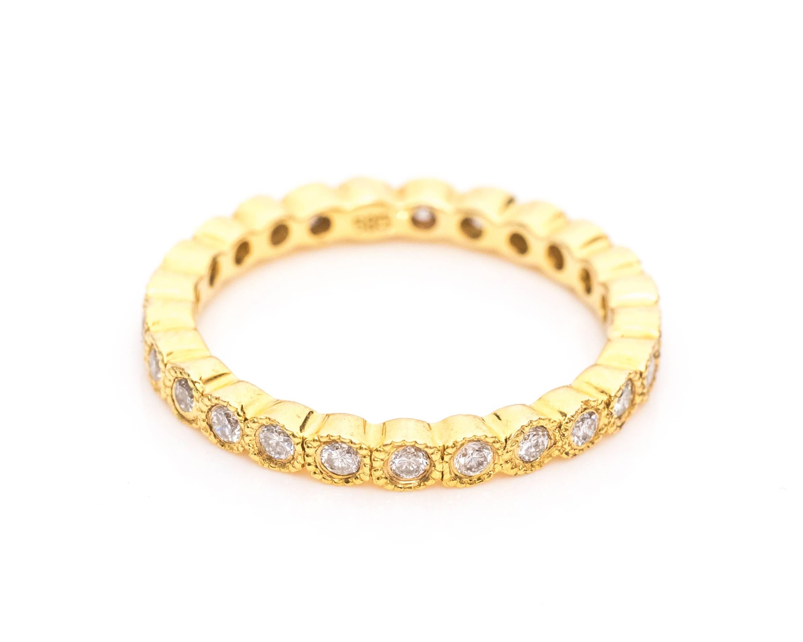 Absolutely beautiful 14 karat yellow gold eternity diamond band ring. 
Each diamond is set in a bezel frame of 14 karat yellow gold with a milgrain pattern along the border. The diamonds surround the entire ring making it an eternity band. 

This
