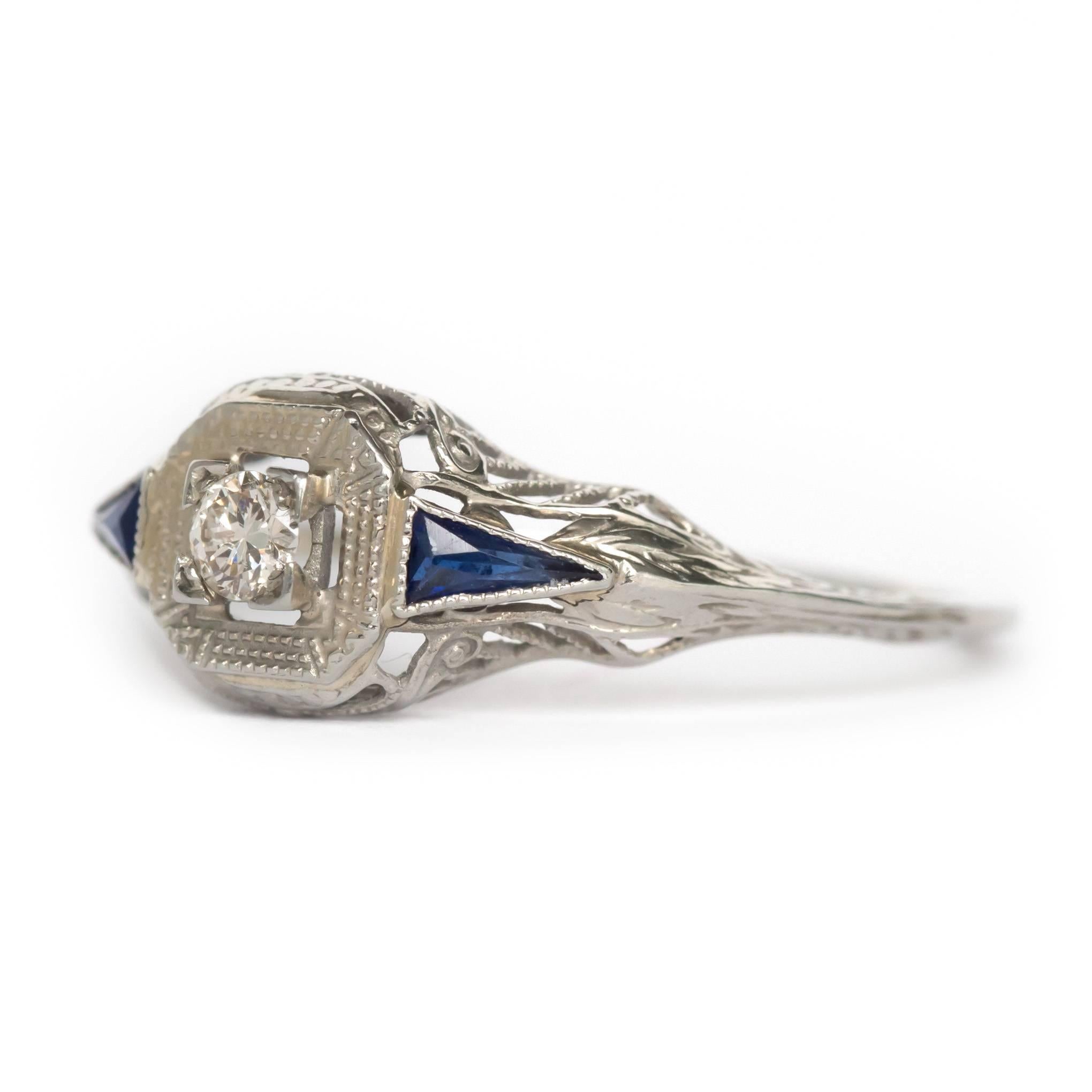 Item Details: 
Ring Size: Approximately 6.9
Metal Type: 18 Karat White Gold
Weight: 1.3 grams

Center Diamond Details:
Shape: Antique Single Cut
Carat Weight: .05 carat
Color: G
Clarity: SI1

Color Stone Details: 
Type: Synthetic Sapphire
Shape: