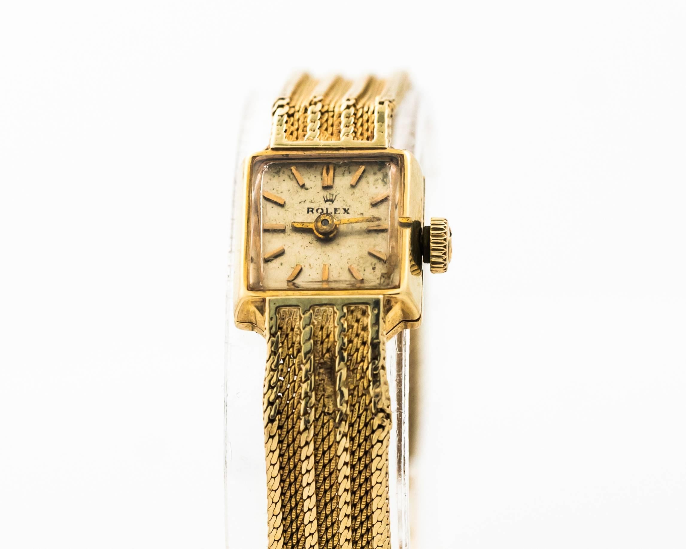 1950s Rolex Wristwatch for Ladies
14 Karat Yellow Gold

Manual Wind
Crown on this watch is Omega Brand. The watch was purchased in a boutique where Omega watches were sold as well. 

Made in France (hallmarked on the clasp)
Band and Dial has some