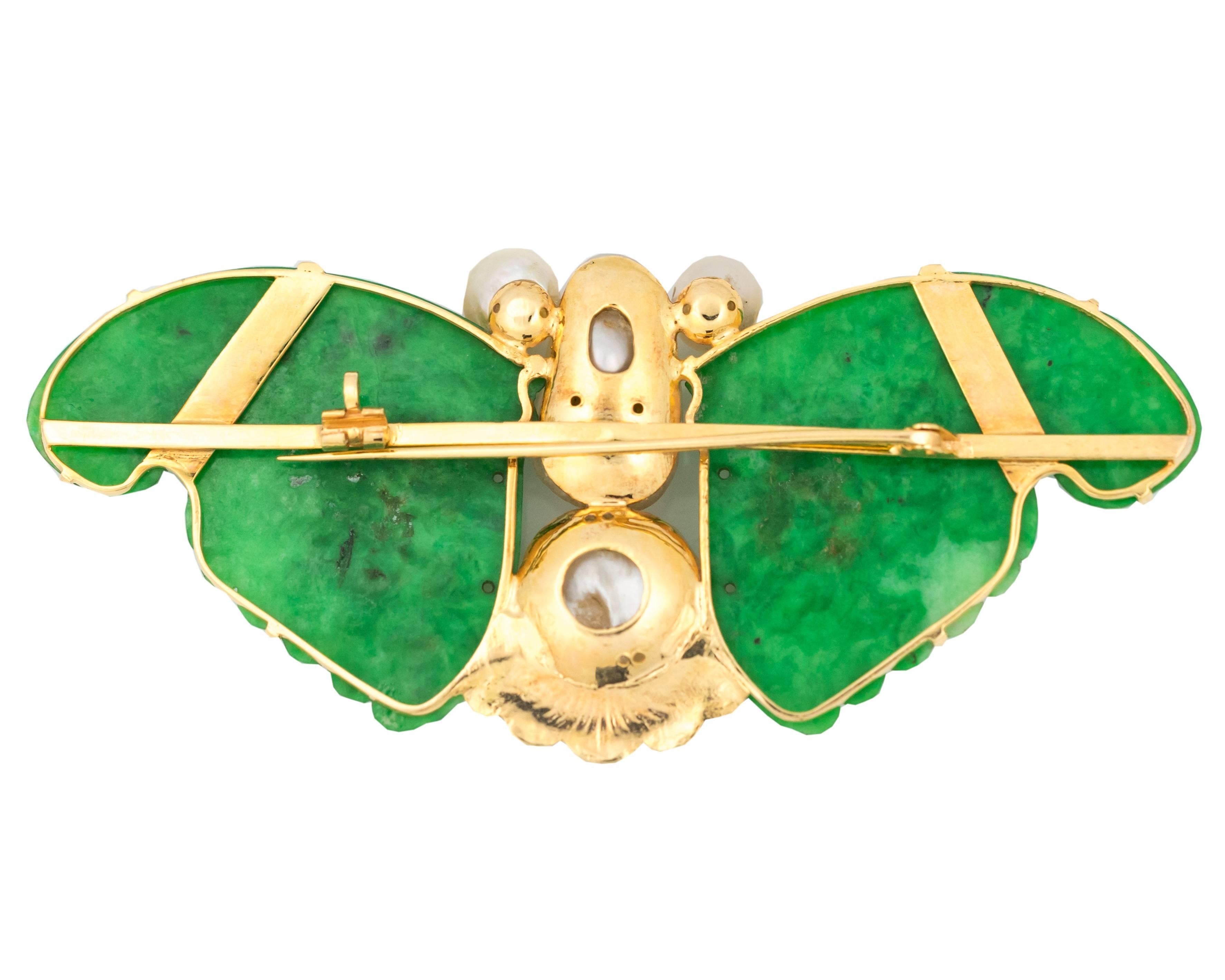 1960s Vintage Butterfly Lapel Pin/Brooch features Jade Wings, Free Form Pearl Body and Eyes and 18K Yellow Gold.

Pearls show minimal signs of wear. The right wing has a tiny crack on the top. The Jade is prong set.

The butterfly measures