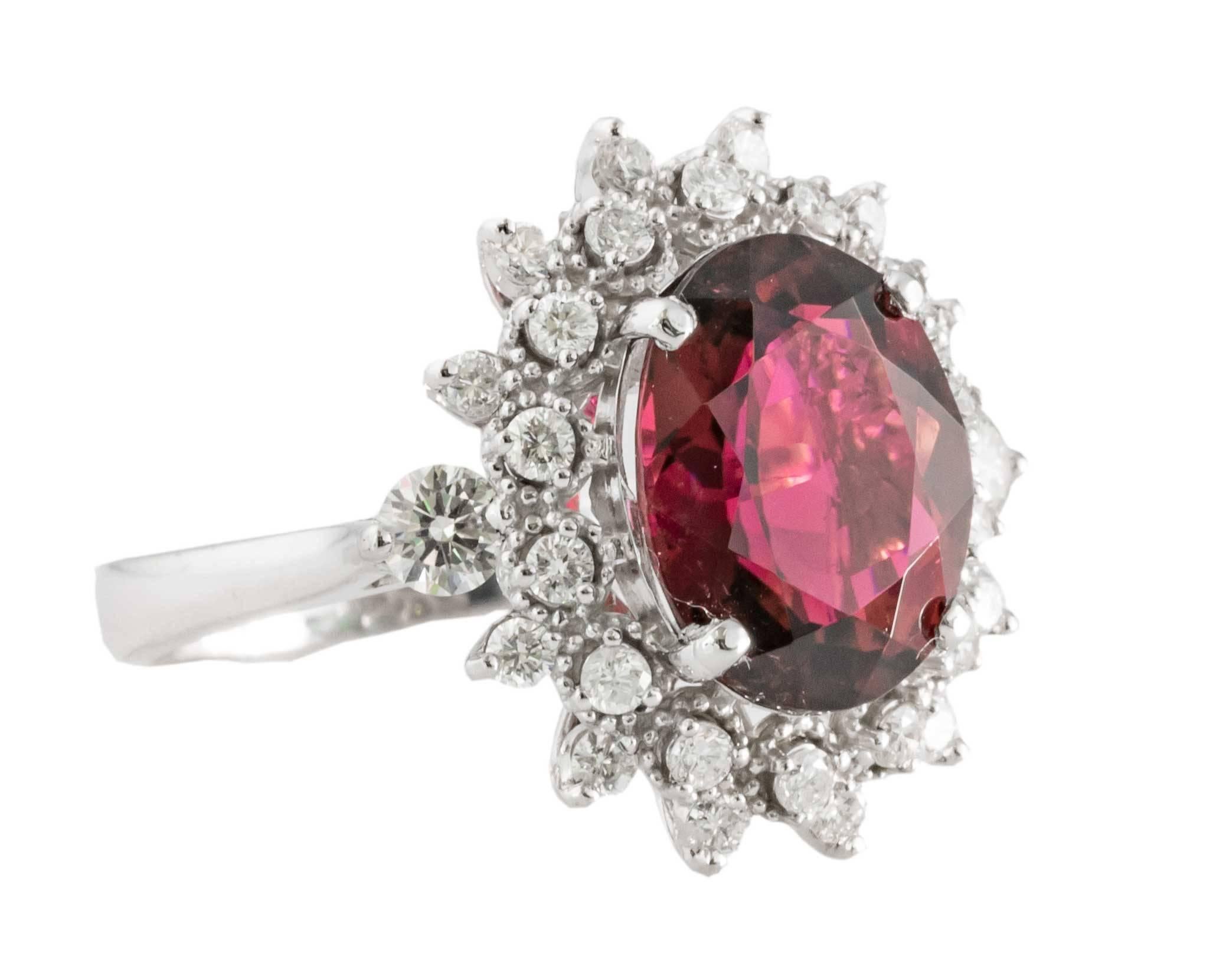 1990s Tourmaline and Diamond Cocktail Ring

Center is a Gorgeous 4 Carat Tourmaline
Oval Brilliant Cut, Natural, Red Tourmaline Prong-Set

Beautifully crafted floral halo of accent diamonds give this ring the perfect amount of sparkle! 
0.80 carats