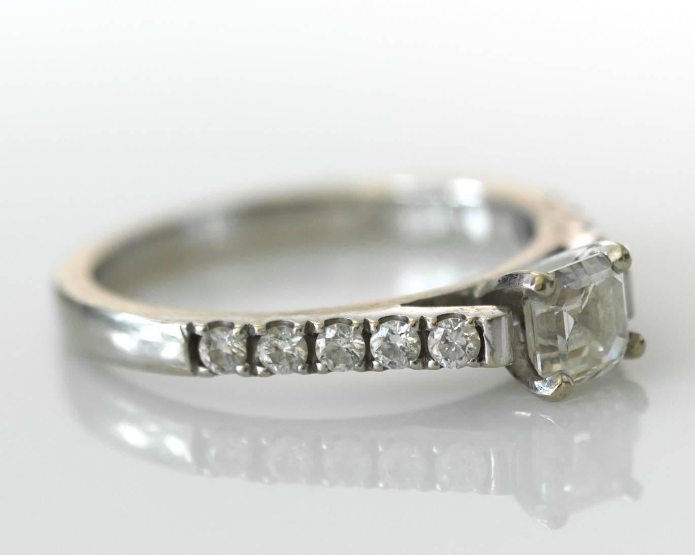 This timeless Asscher cut Diamond Ring is GIA certified, certificate number 1146648085. 

The square emerald cut center stone weighs .56 carats and the 10 round accent diamonds, total .25 carats total weight. 

All stones are set in 14 karat white