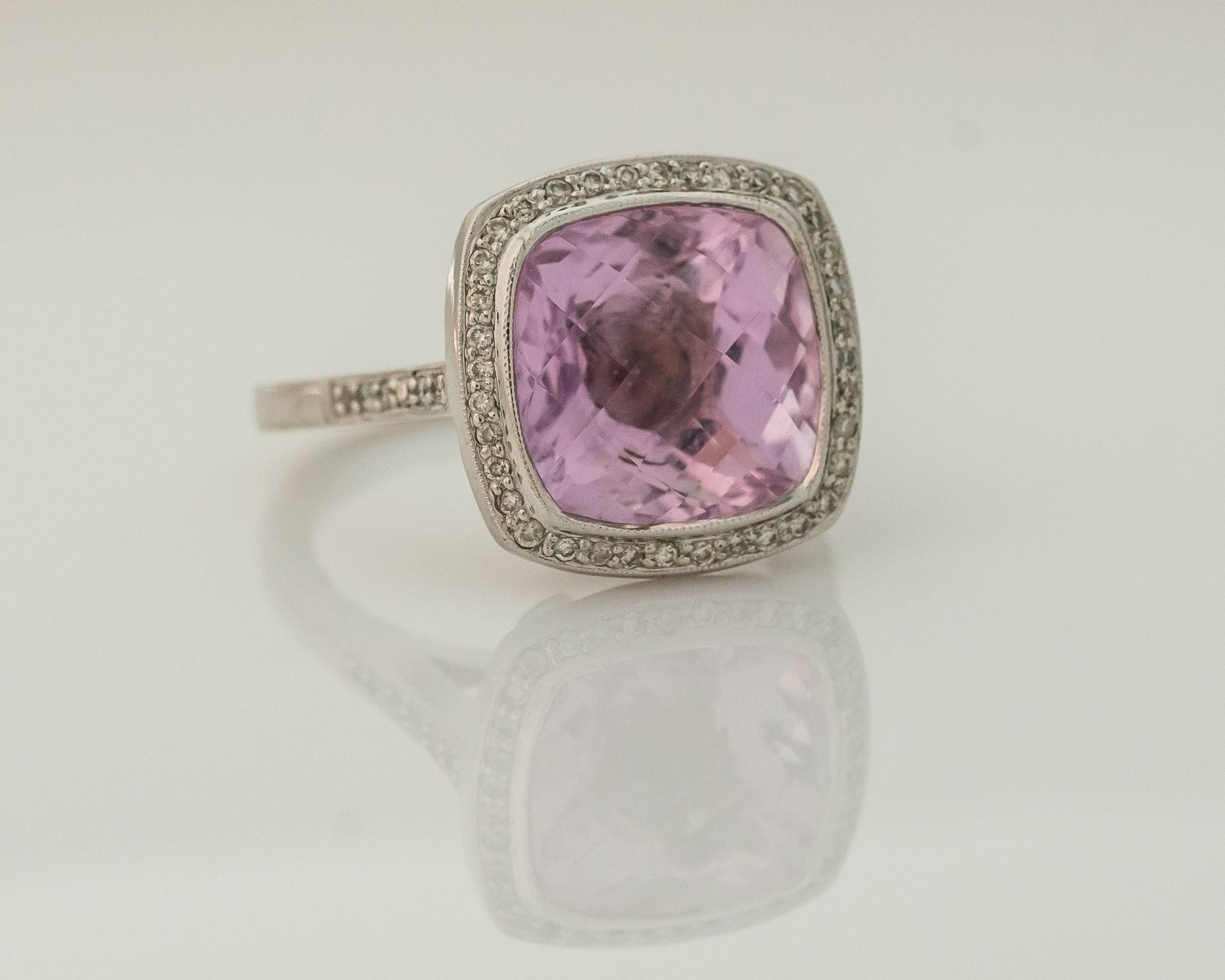 This gorgeous 1990s 4 Carat Square Pink Topaz ring features a Halo of round brilliant Diamonds set in 14 Karat White Gold. The cathedral mount setting has a single row of diamonds on each of the 2 sides of the shank leading up to the halo. There is