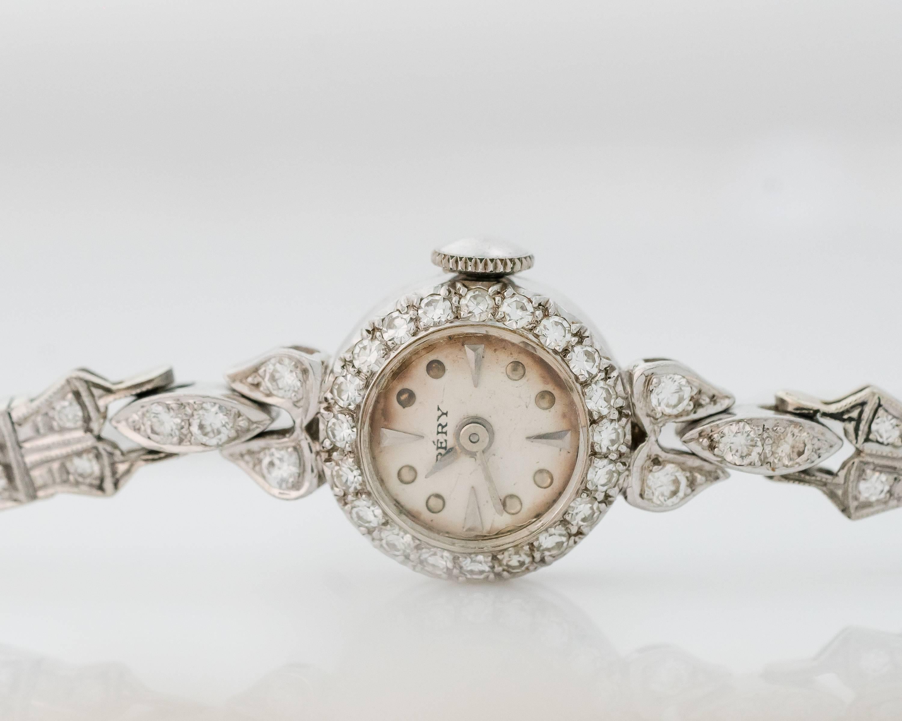 This 1920s Art Deco Pery 2 Carat Diamond and Platinum ladies watch is dainty and delicate.
It features 2 carats total weight of single cut diamonds set in platinum along the bezel, lugs and bracelet. 

The bracelet fits a 6.5 - 7 inch wrist and has