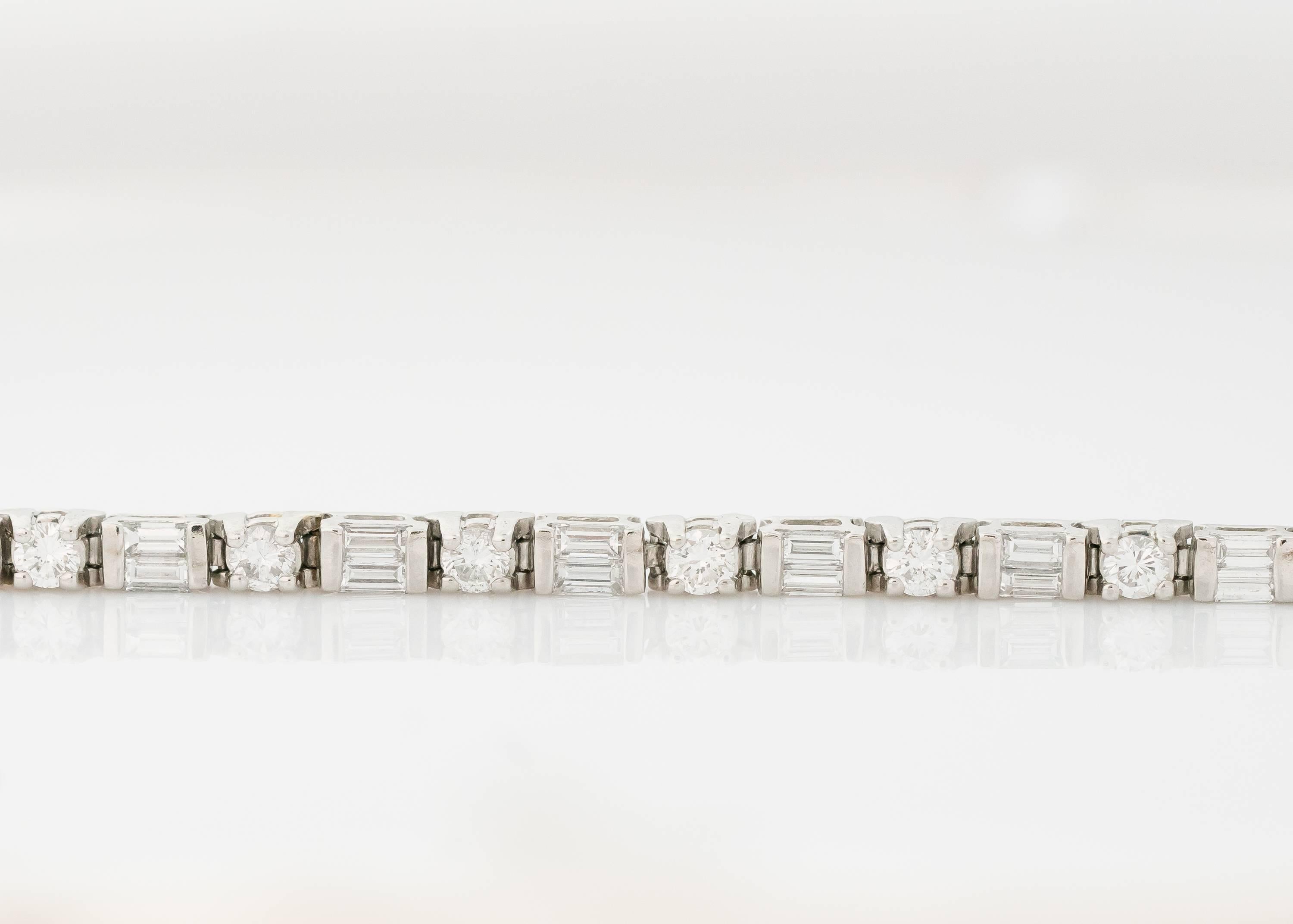 Gorgeous! You will want to wear this 1970s Diamond and Platinum Tennis Bracelet every day. This beautiful bracelet has 5 carats of alternating baguette and round brilliant diamonds set in platinum. It also has a double safety clasp for added