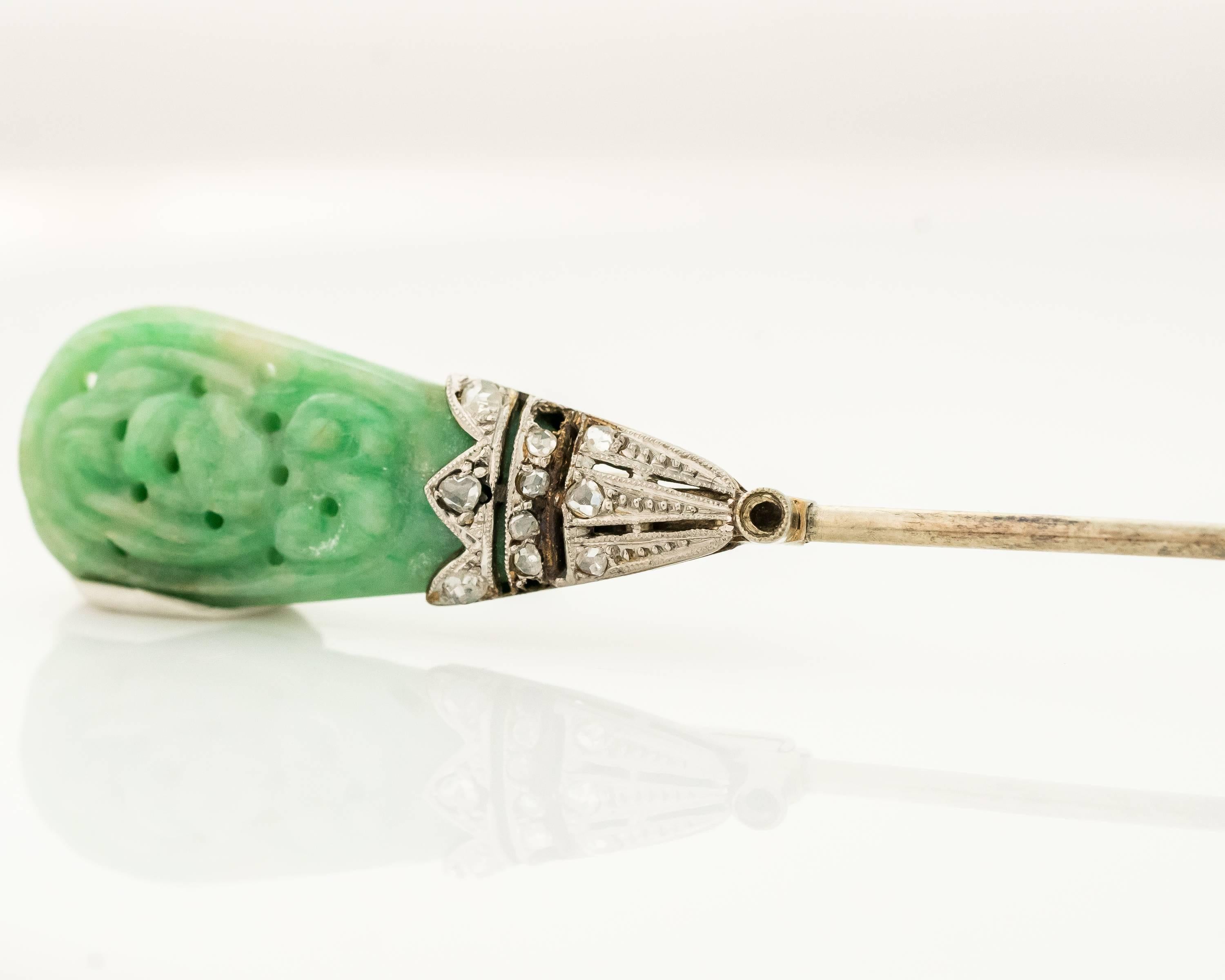 This 1890s floral motif Jade and Diamond Jabot Pin will add an elegant touch to any ensemble. Each end of the 14 karat white gold pin features a delicately carved Jade flower nestled in a 14 karat white gold with Rose Cut Diamonds end cap. This