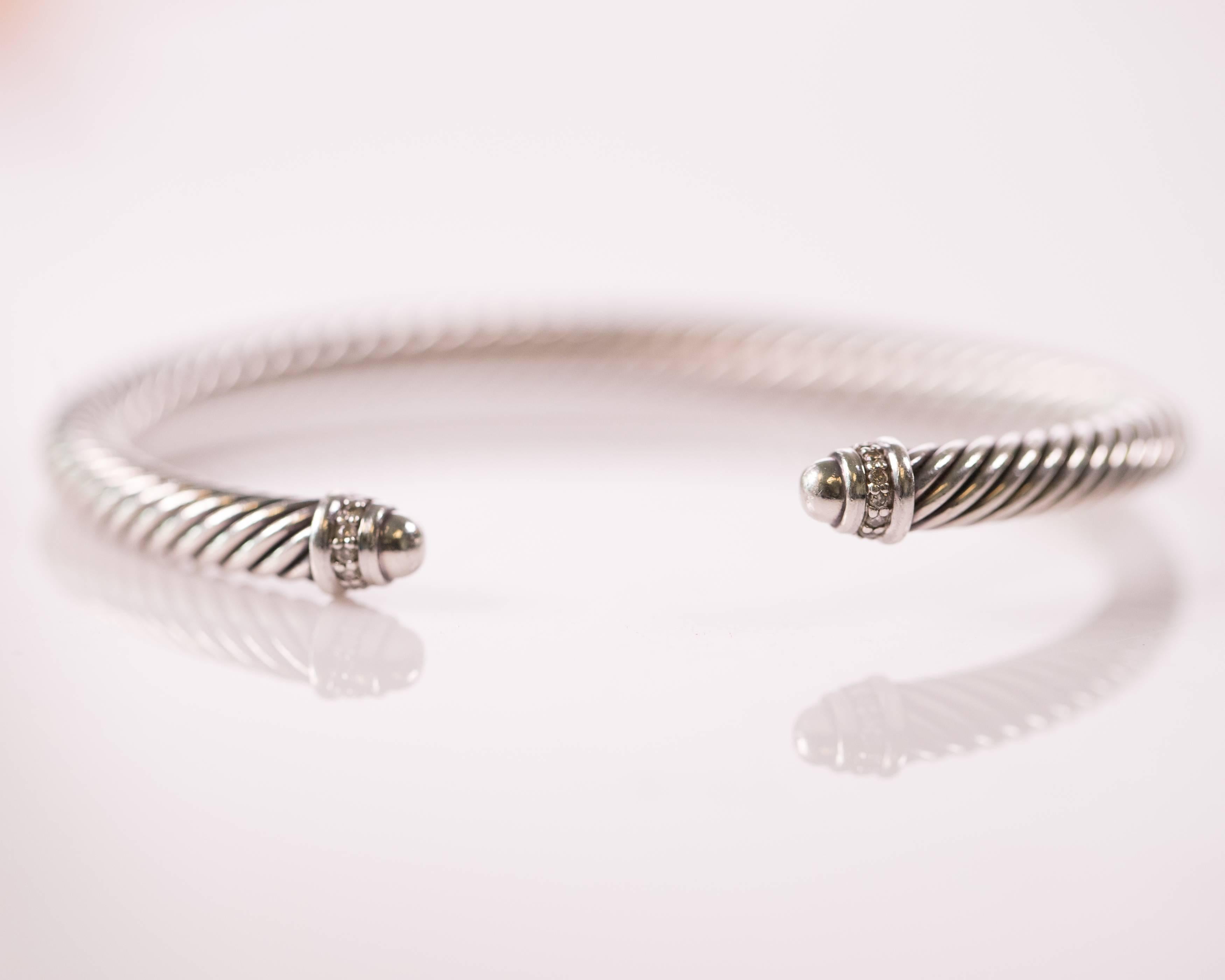 Wear this David Yurman Cable Classics Bracelet with Diamonds every day! The twisted cable bracelet is made from Sterling Silver and measures 5 millimeters thick. On each end of the cable is a sterling silver cap featuring a band of pave diamonds and