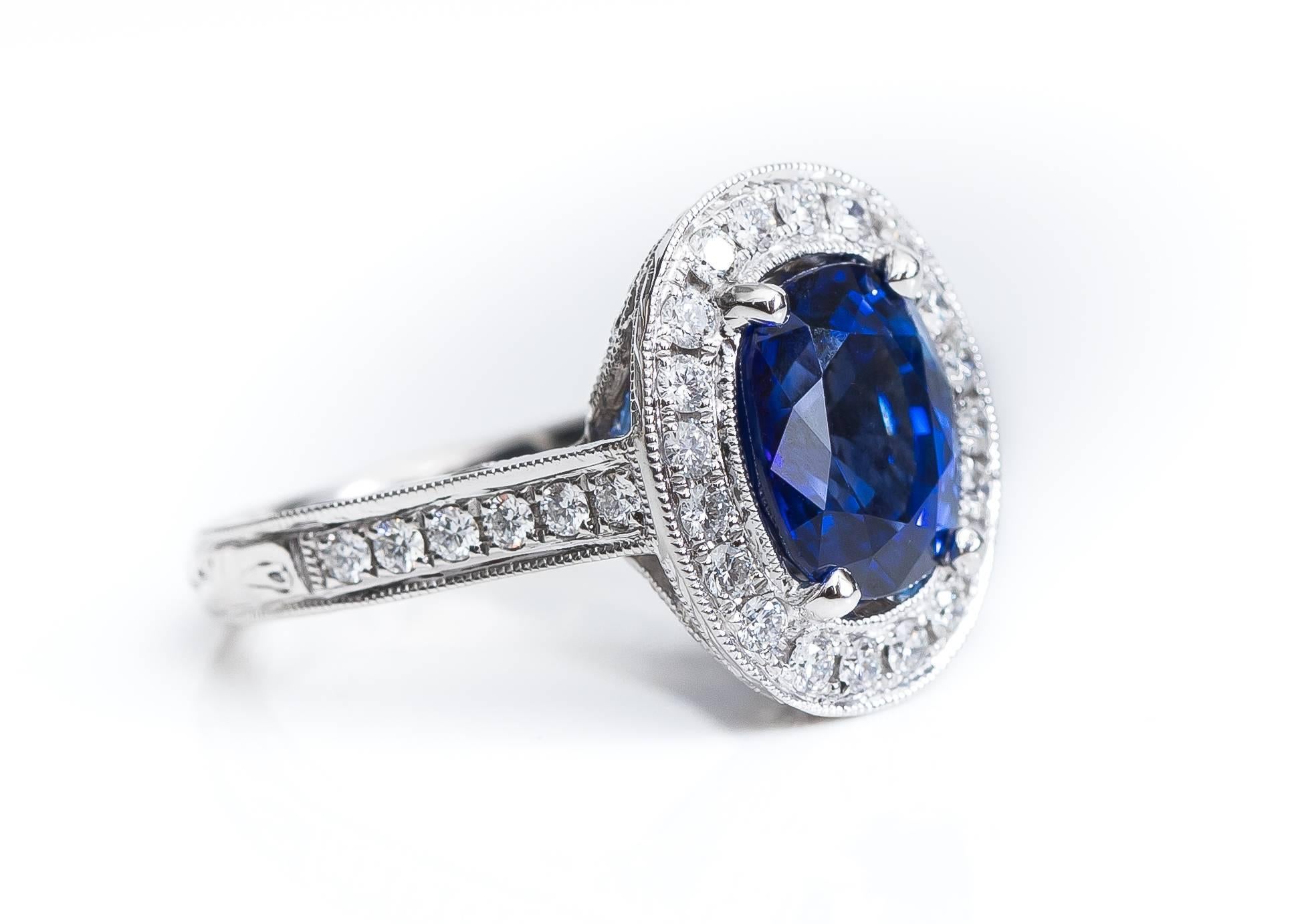 This GIA Certified 3.75 Carat Madagascar Cornflower Blue Sapphire Ring features a Diamond Halo and Platinum setting. The Sapphire center stone measures 9.29 x 7.91 x 5.6 millimeters and is Cornflower Blue, the most desirable Sapphire color. A