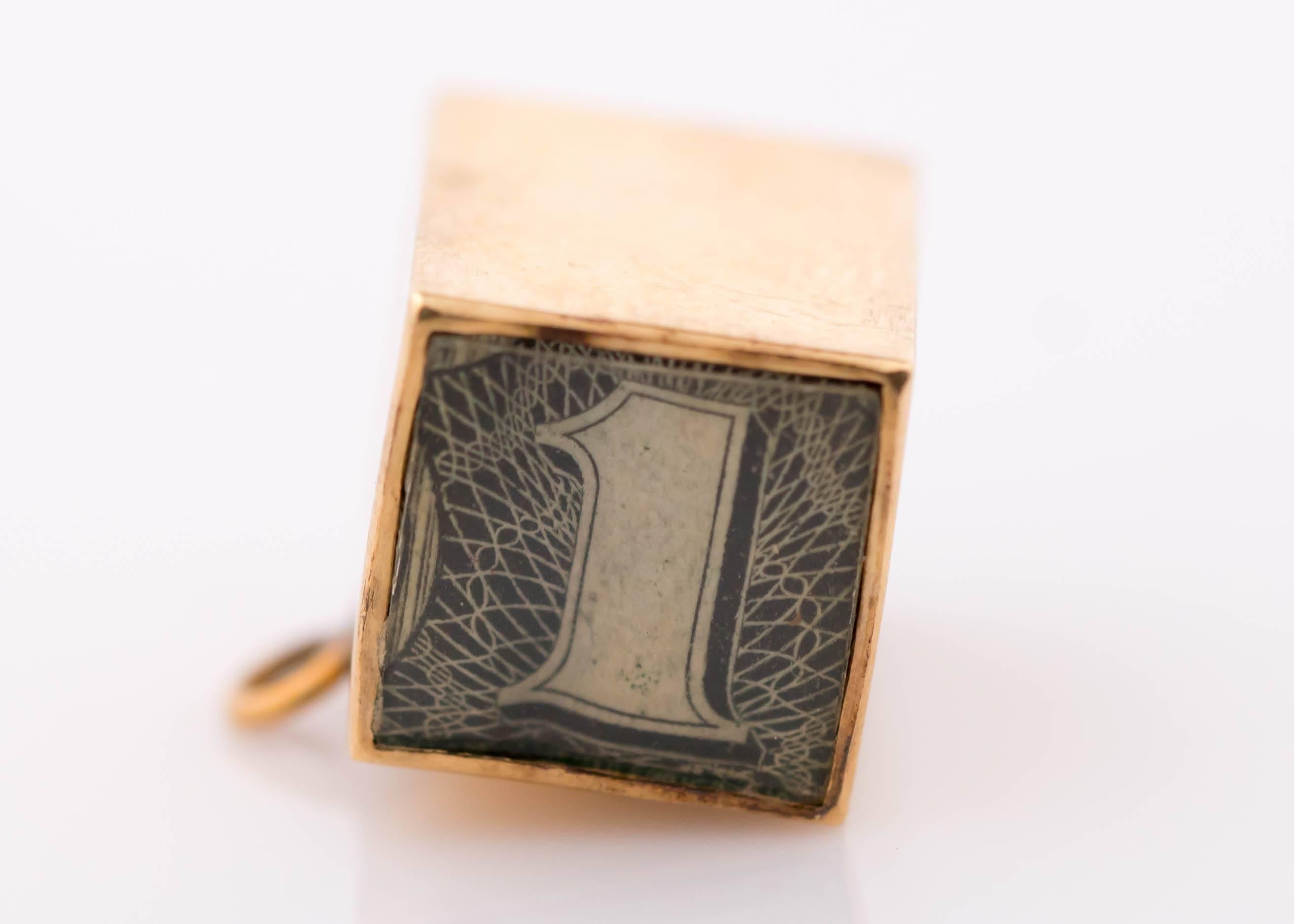 1950s A.C. $1 Dollar Cube Charm - 14 Karat Yellow Gold
Engraved: IN EMERGENCY BREAK GLASS

This Unique, One of a Kind Charm makes a great Pendant or Charm addition to your favorite bracelet or necklace. The cube is 14 Karat Gold on 4 sides with