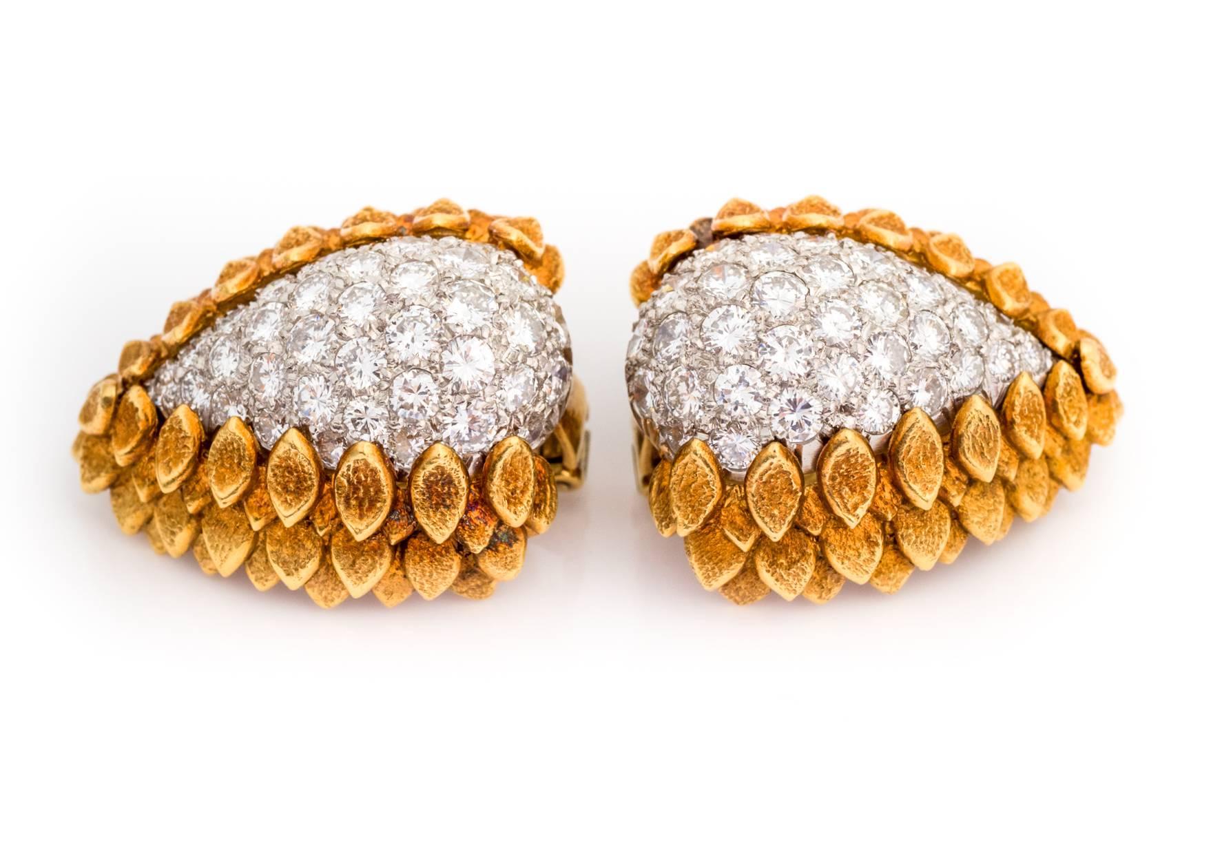A fine pair of diamond and 18k yellow gold leaf motif earrings with clip on clasp mechanism that flips up or down. Several tiers of yellow gold stacked leaf frames surround the stunning diamond cluster weighing 4.05 carats. A superb crafted pair of