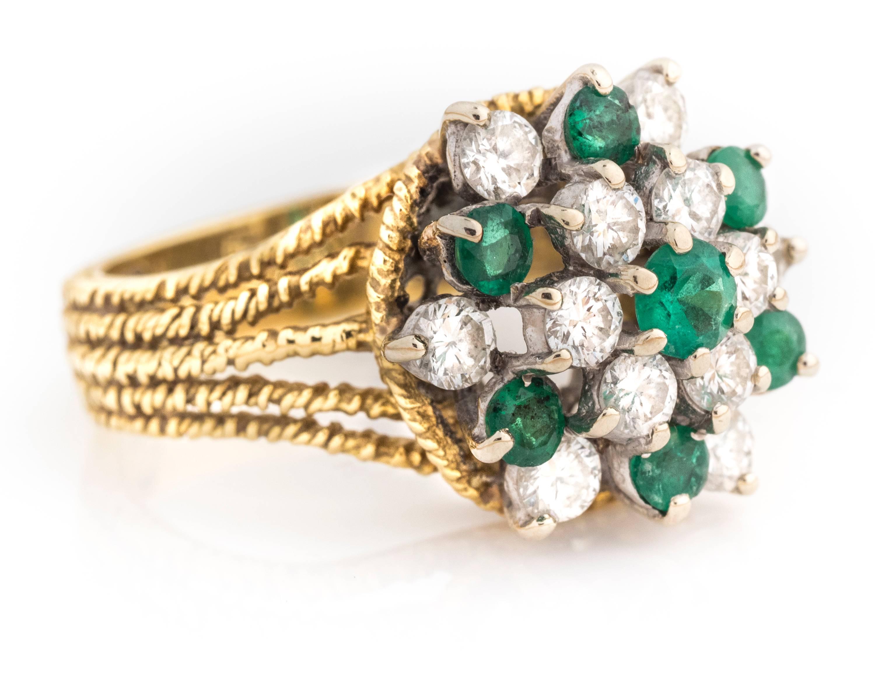 Glowing late 20th century cocktail ring by Hammerman Brothers (signed HB). This ring features a gorgeous bouquet of vivid green Colombian emeralds and round brilliant diamonds on white gold prongs. The prongs further enhance an ornate yellow gold