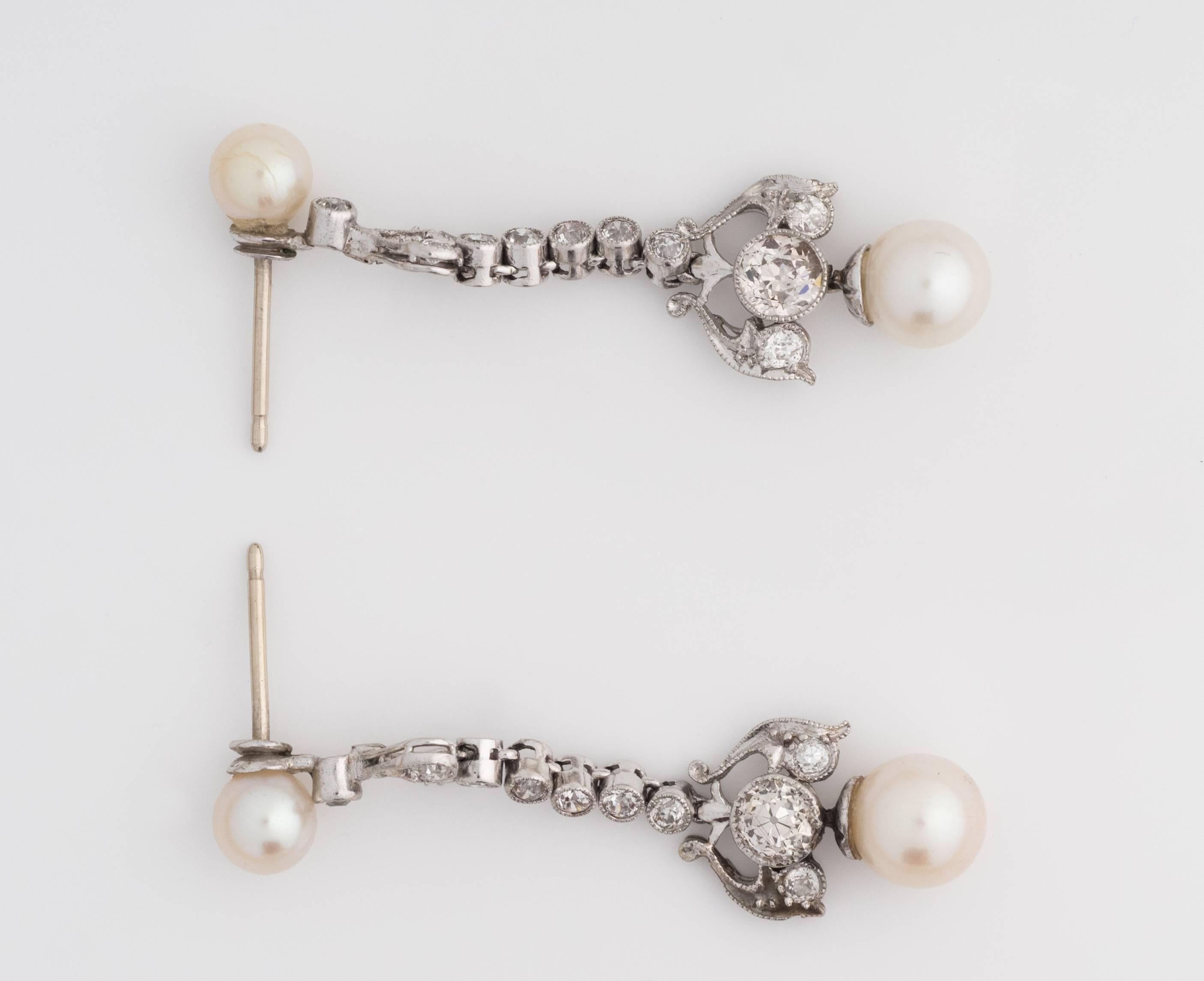 
Gorgeous Art Deco era 14k White Gold Chandelier style classic earrings. Stunning Old Miner Diamonds (1.75cttw) are seen throughout the setting with one Pearl drop accent. The old miners boast H-J color, VS-SI2 clarity. The pearls are fresh water
