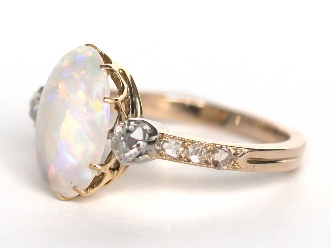 Item Details: 
Ring Size: 4 
Metal Type: 14 Karat Yellow Gold with Platinum Prongs
Weight: 3.2 grams

Color Stone Details: 
Type: Opal
Shape: Oval
Carat Weight: 2.50 carat
Color: Natural 

Side Stone Details: 
Shape: Antique Rose Cut and Antique Old