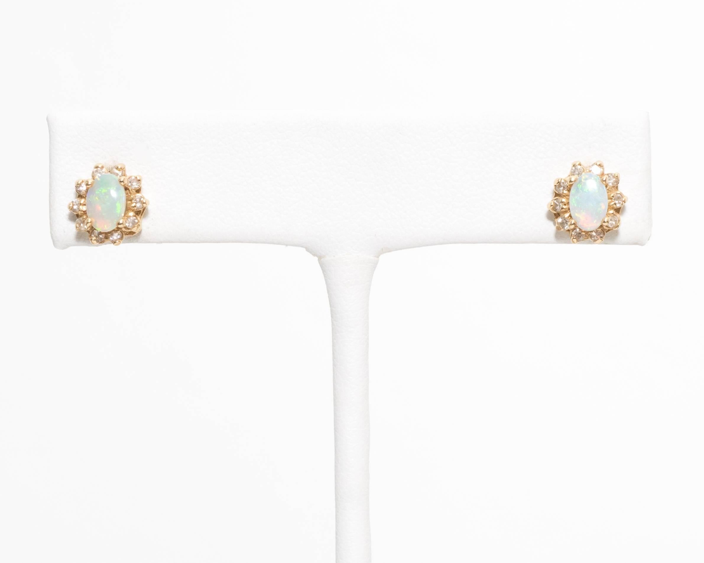 One can never go wrong with a pair of opal and diamond studs! This lovely pair totals 2 grams and has 0.10 carats of diamonds dancing with light around the gorgeous opal tone. 

Crafted in 14 Karat Yellow Gold
Feature a Pushback mechanism for extra