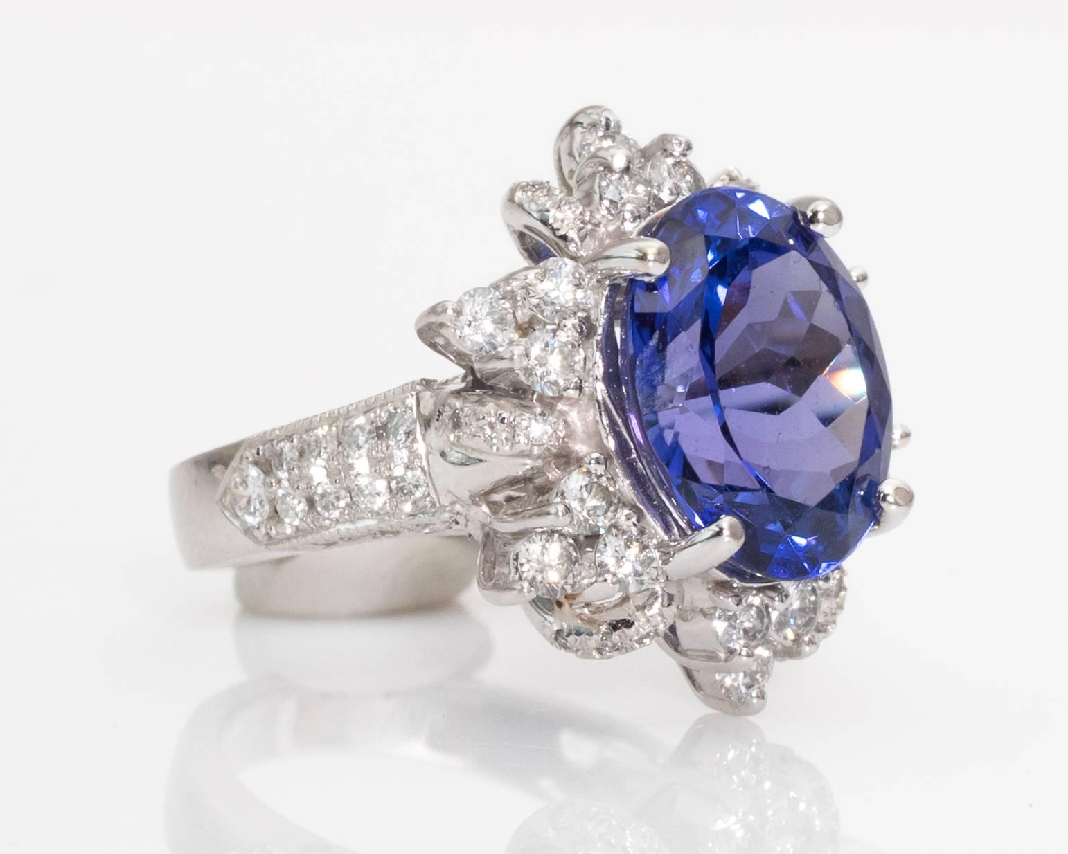 Bathe your hand in brilliance when you wear this timeless tanzanite with sparkling diamond floral surround in 14 karat white gold ring. This beautiful ring dates back to the 1980s. 

Ring Details:
Metal Type: 14 Karat White Gold
Ring Size: 4.5