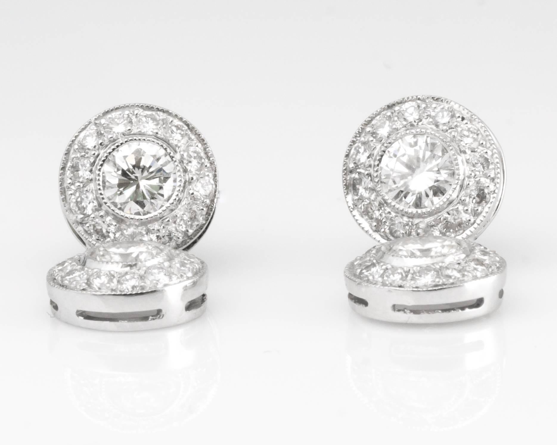 These spectacular Diamond Drop earrings are just waiting to be taken out and shown off! Each earring features 2 bezel set center diamonds surrounded by a halo of accent diamonds set in 14 karat white gold. These post earrings have push backs for