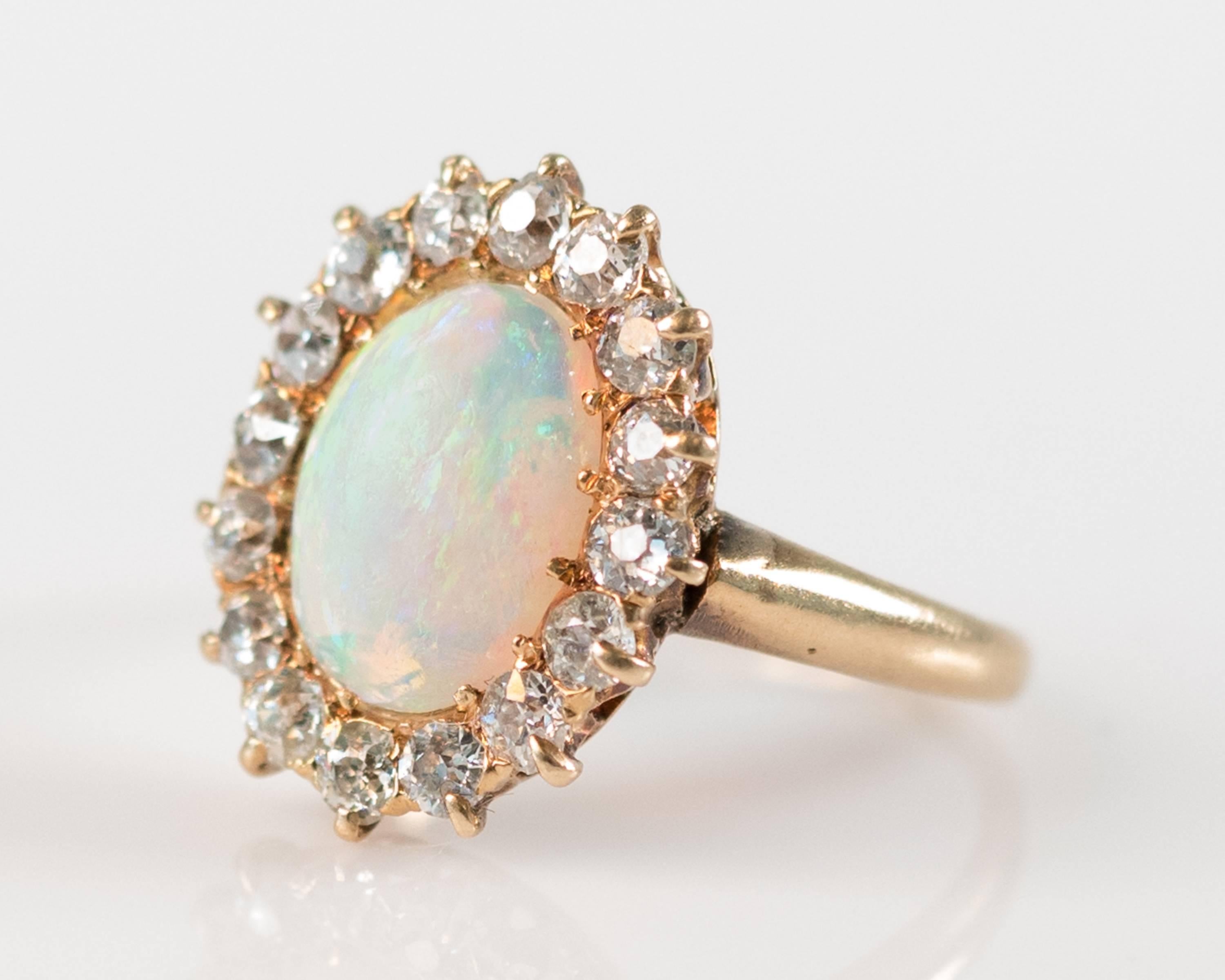 This stunning 1890s antique 4 Carat Opal ring features a gorgeous sparkling halo of Old Mine Cut Diamonds, weighing 2 carats total. The setting is 18 karat yellow gold. This delicate ring fits a size 3 finger but can be resized with ease.
All