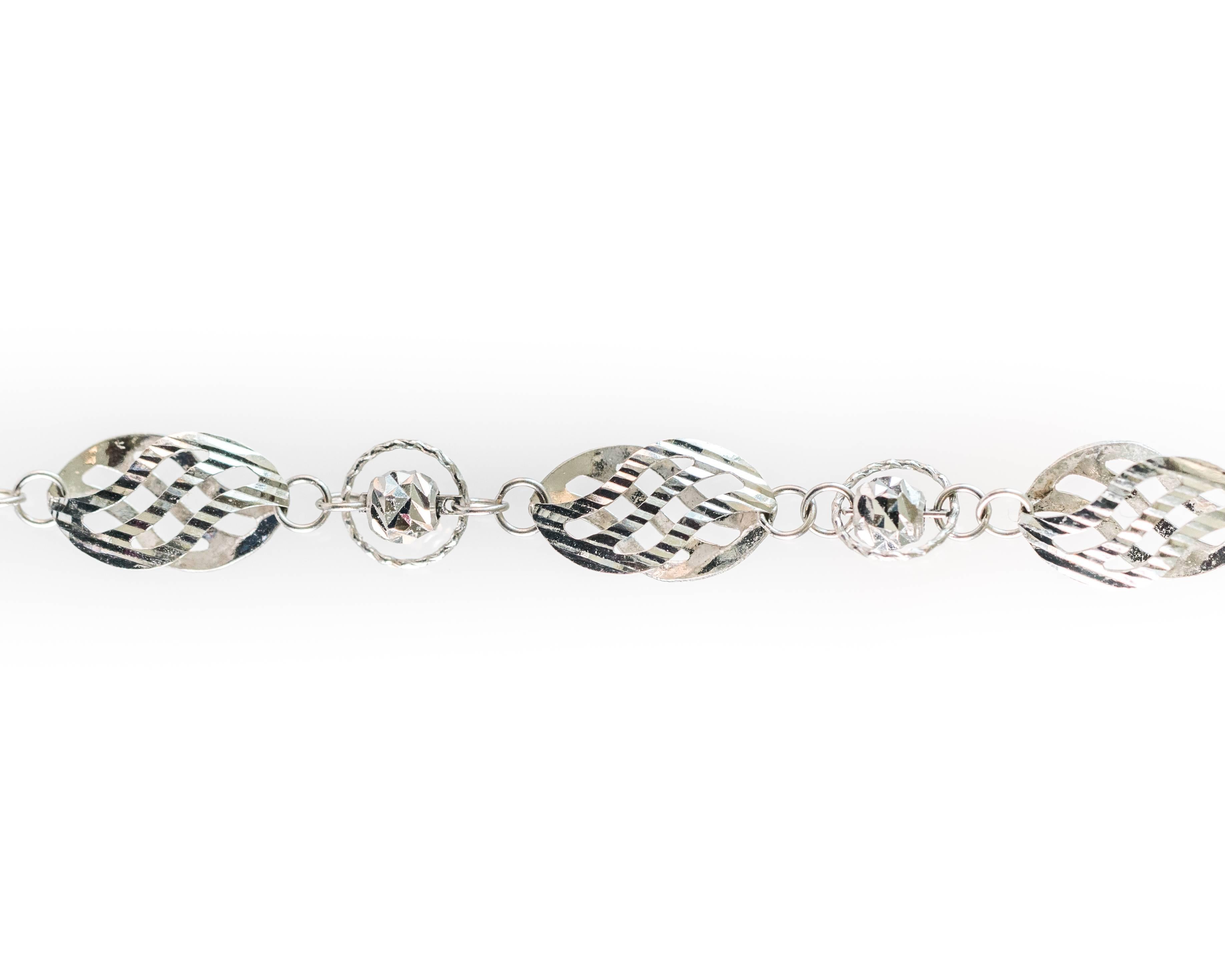 This handmade bracelet from Italy was precision cut by diamond lasers which gives the links a very polished and brilliant look. From a distance, the gold spheres look like diamonds! This bracelet has an alternating pattern of small gold spheres