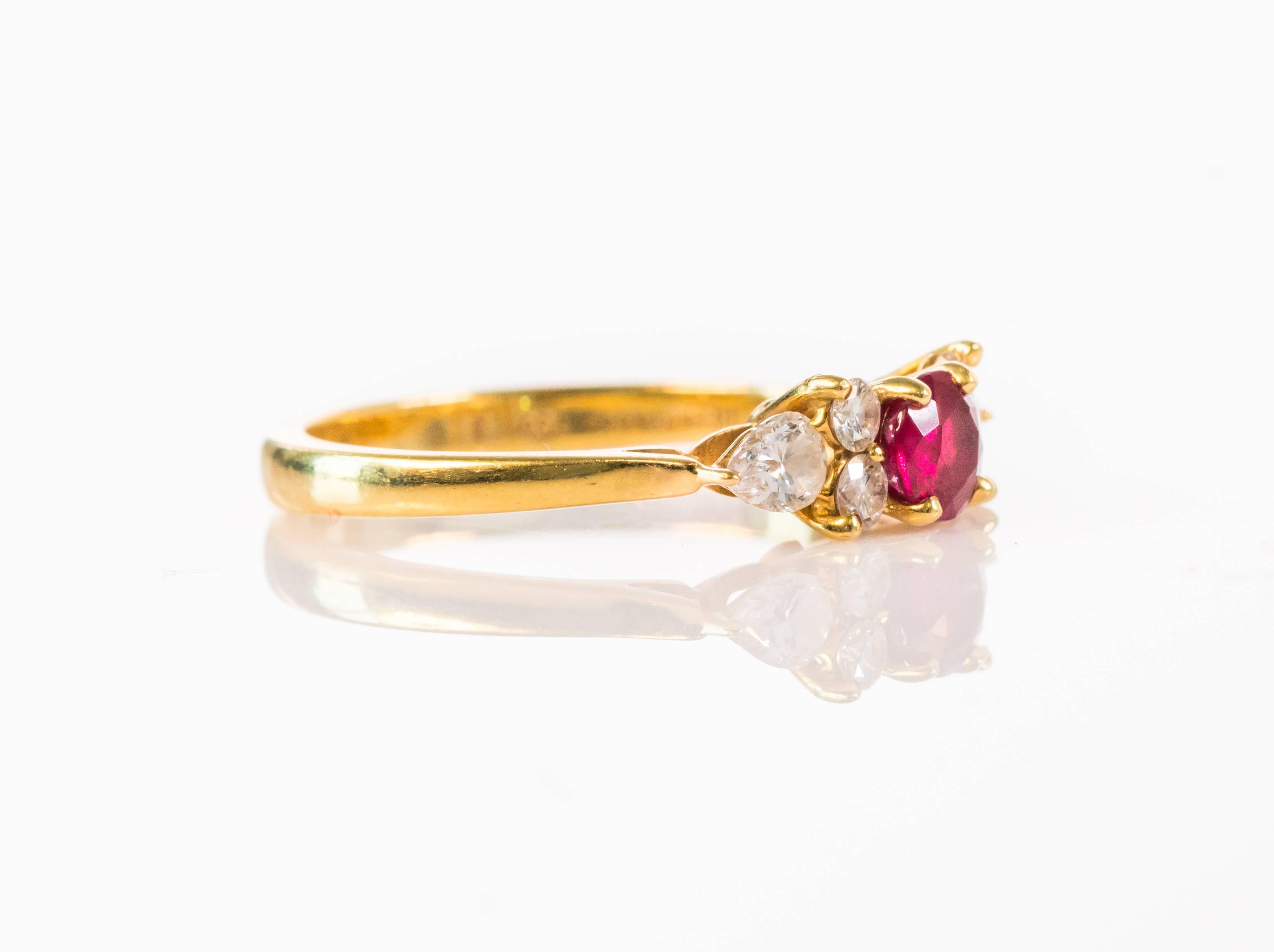 This vintage 1980s Tiffany and Co prong set Red Ruby, Diamond and 18 Karat Yellow Gold ring makes a perfect gift for your favorite sweetheart! The .40 carat red ruby is flanked by 4 round brilliant diamonds and 2 pear-shaped diamonds. This ring fits