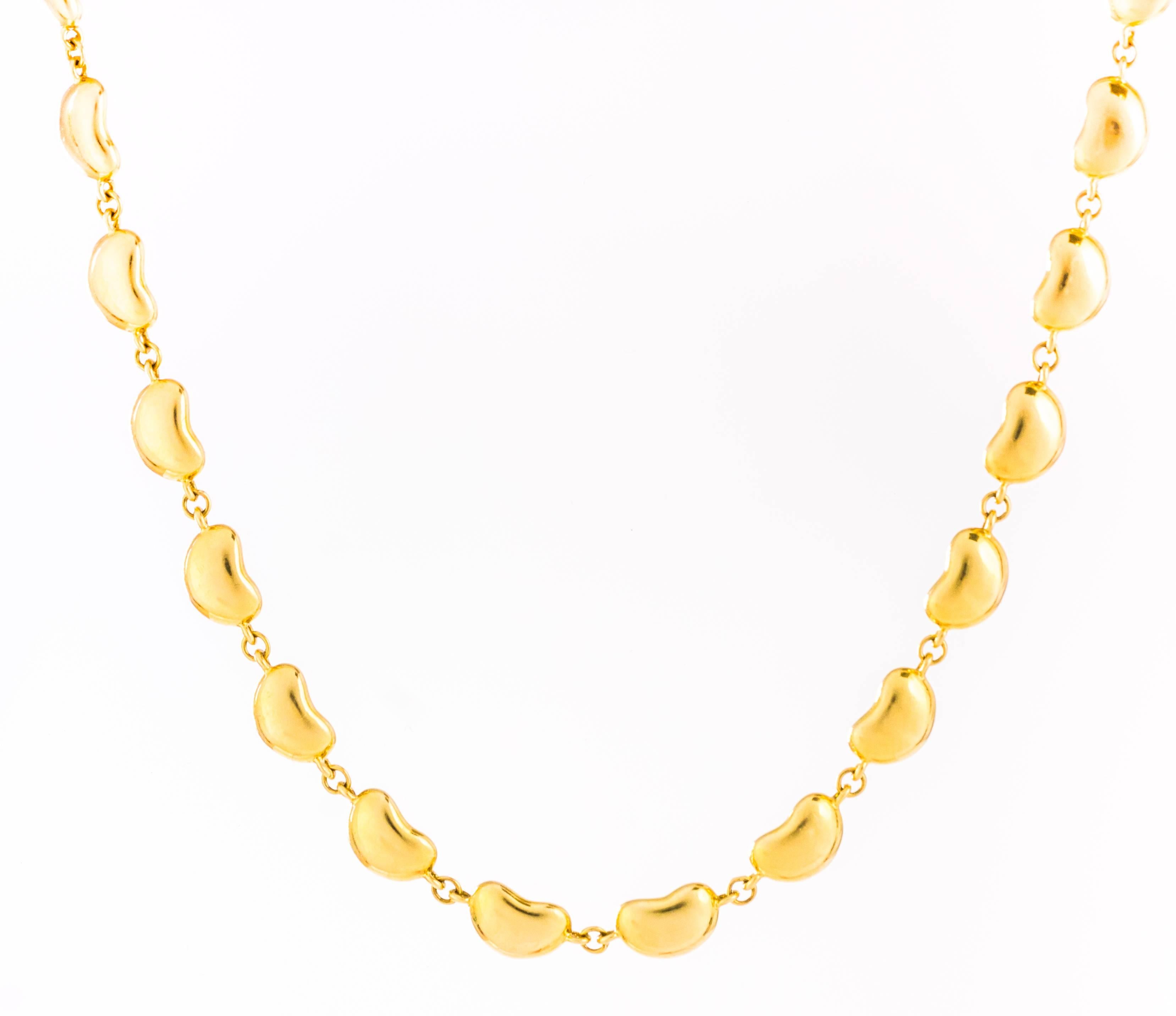 This very rare 1990s Tiffany and Co. Elsa Peretti Bean Collection necklace has 38.8 grams of 18 Karat Yellow Gold. Most of the Bean collection necklaces were produced in silver, not gold. Each bean link measures approximately 7.5 millimeters by 5