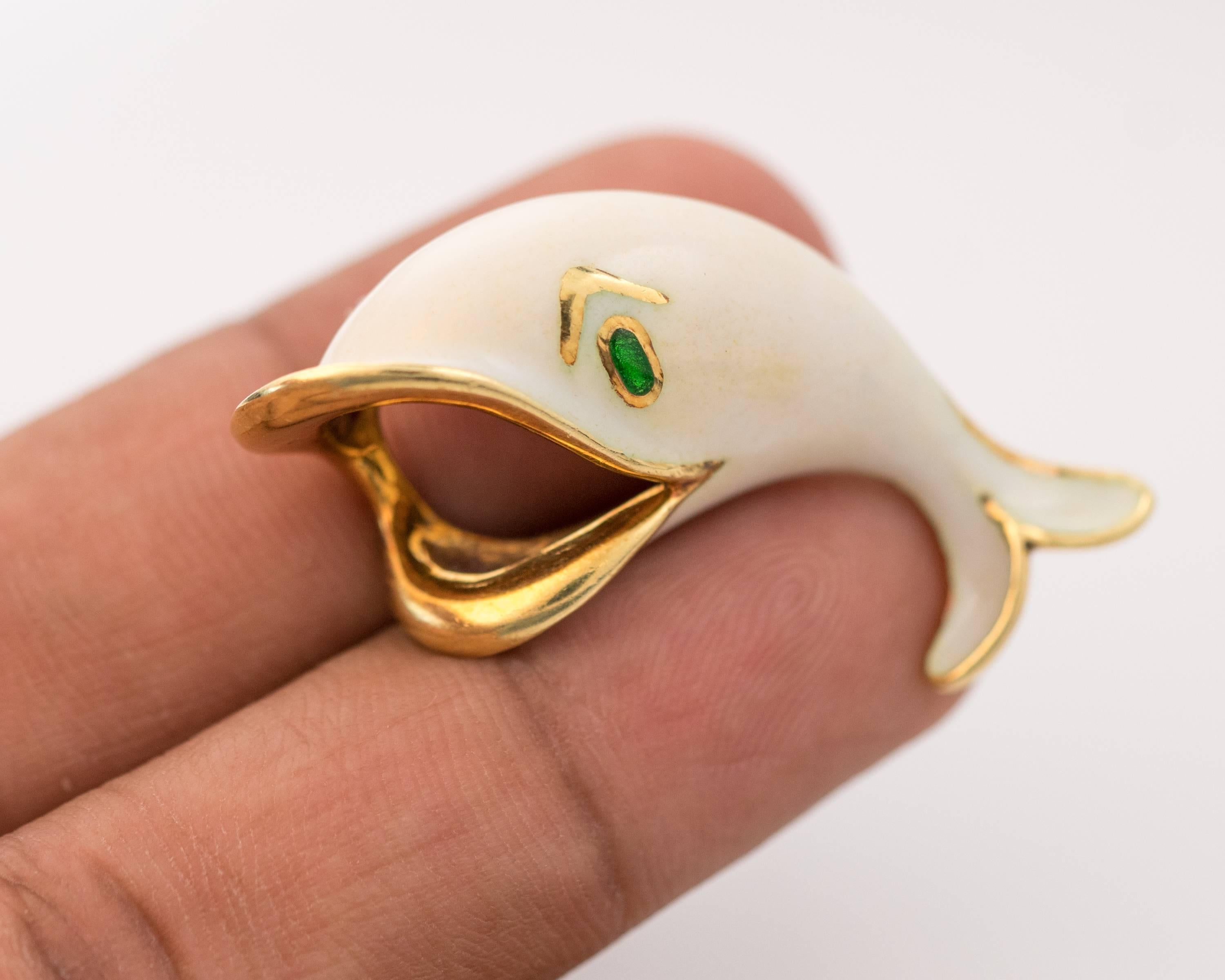This lovely 1950s Whale Brooch features a white enamel body with a green enamel eye outlined in 18 karat yellow gold. Brooch or Lapel Pin, you choose! This 1950s whimsical 18 karat yellow gold and enamel whale pin makes a perfect accessory for women