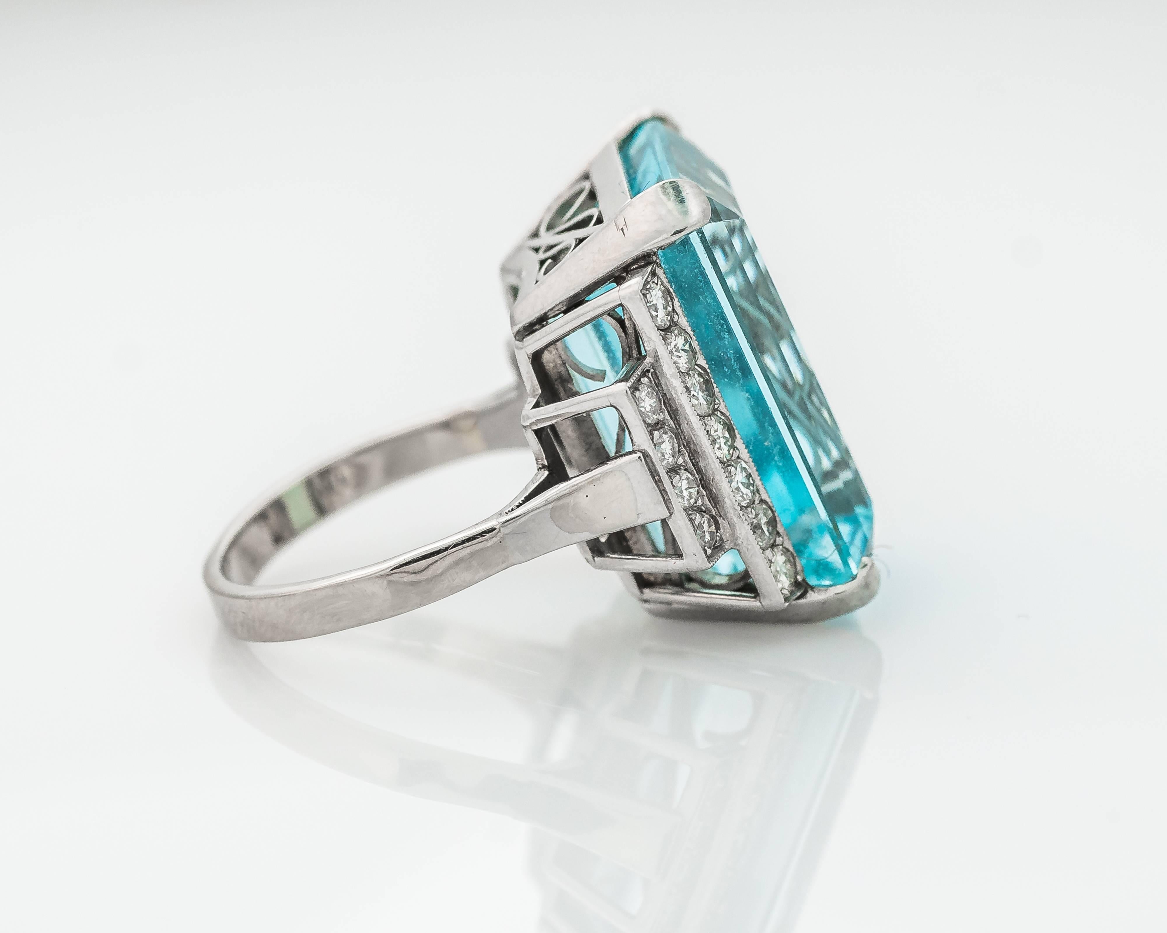 This dazzling 1964 14K White Gold, Diamond and Aquamarine Ring features a 20 carat emerald cut Aquamarine held securely in place by 4 cut corner square prongs. Measuring 21 millimeters long x 14 millimeters wide, this gorgeous Aquamarine is flanked