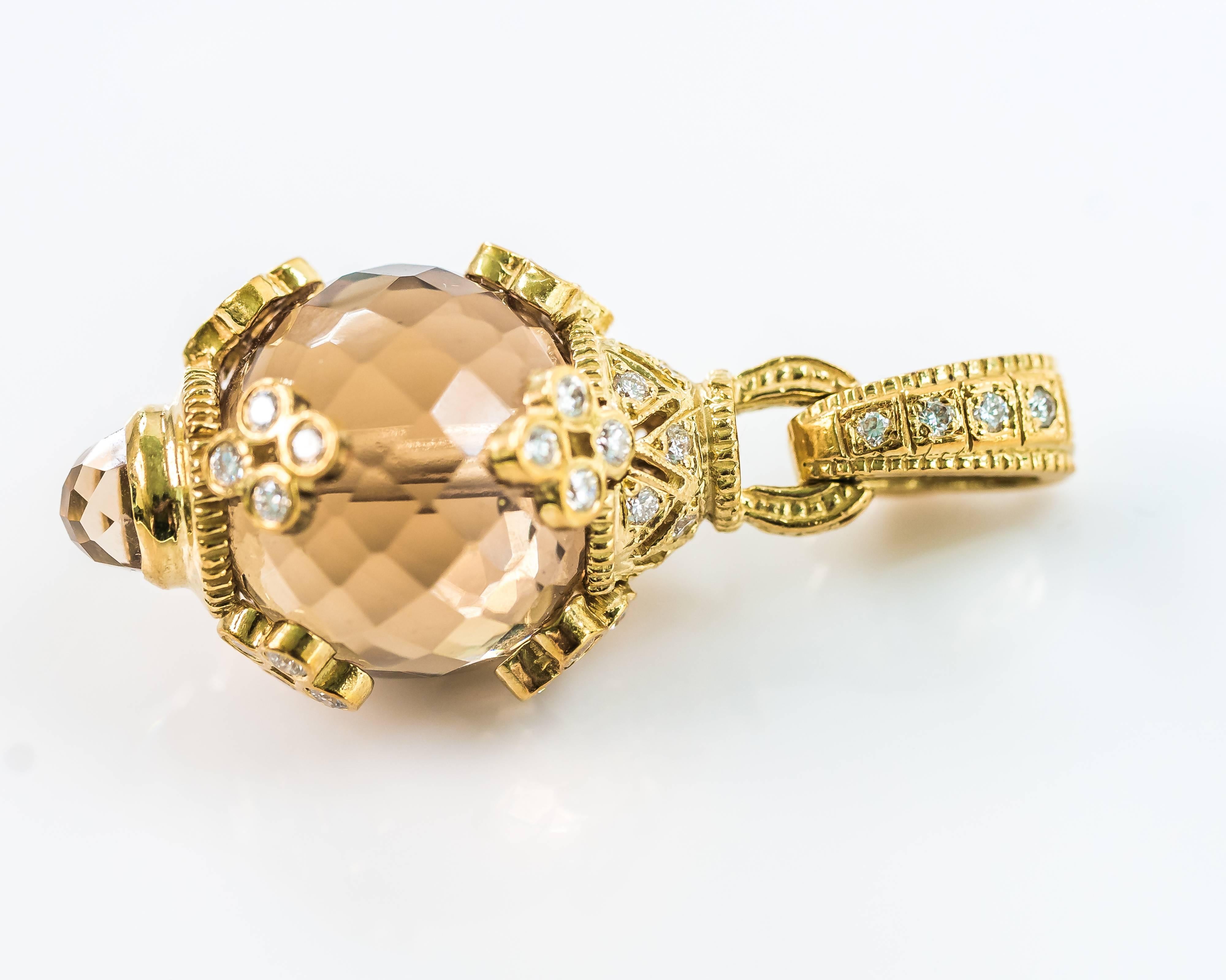 This Citrine and Diamond in 18 karat yellow gold pendant features a Citrine ball charm, 36 bezel set diamonds and a locking bail which opens to fit a slide chain or necklace. A petite bezel set citrine ball adorns the bottom of this enhancer. This