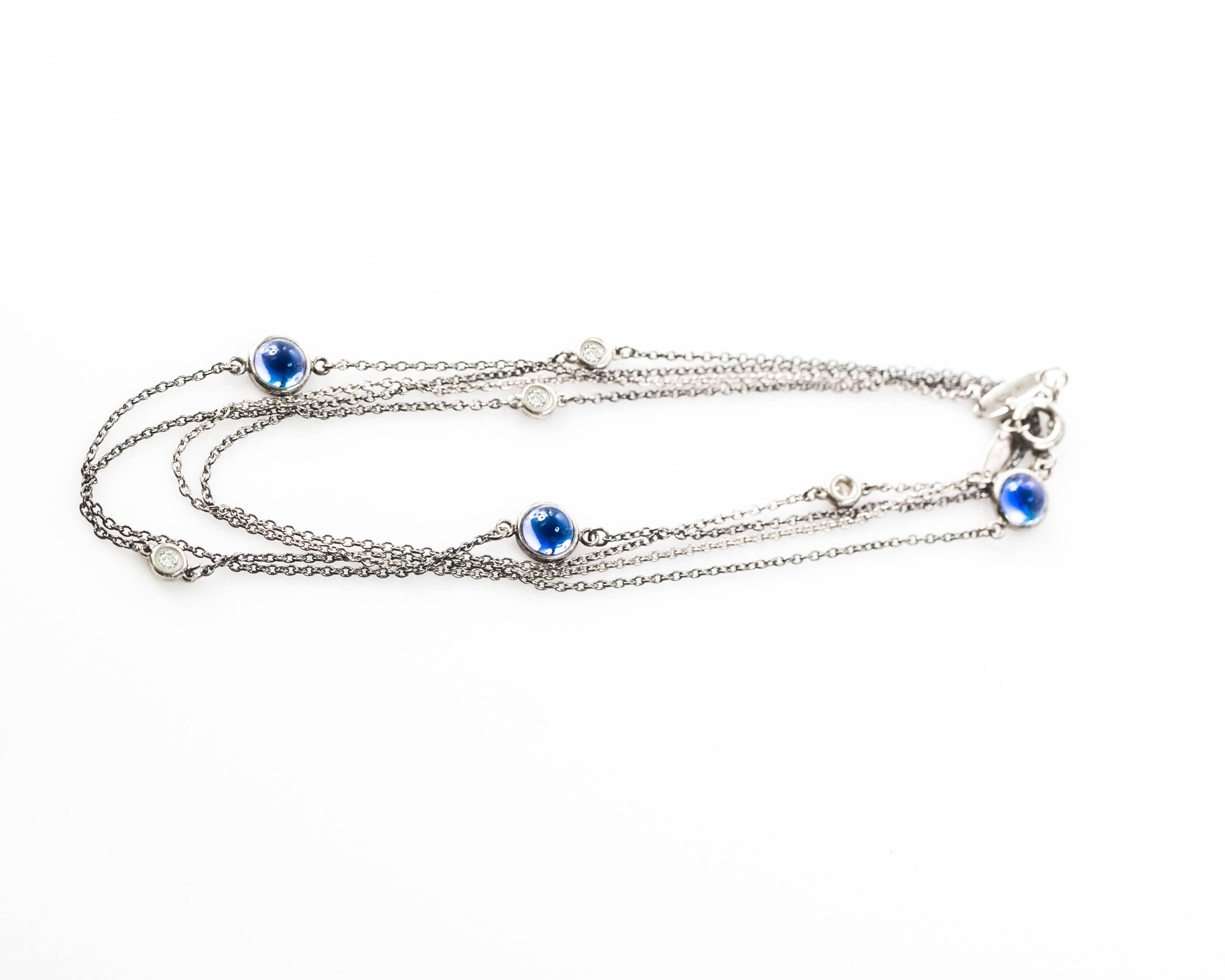 This elegant Tiffany and Co. Elsa Peretti Blue Sapphire, Diamond and Sterling Silver Diamonds by the Yard necklace features 3 bezel set blue sapphires and 4 bezel set diamonds arranged in an alternating pattern along the Sterling Silver chain. You