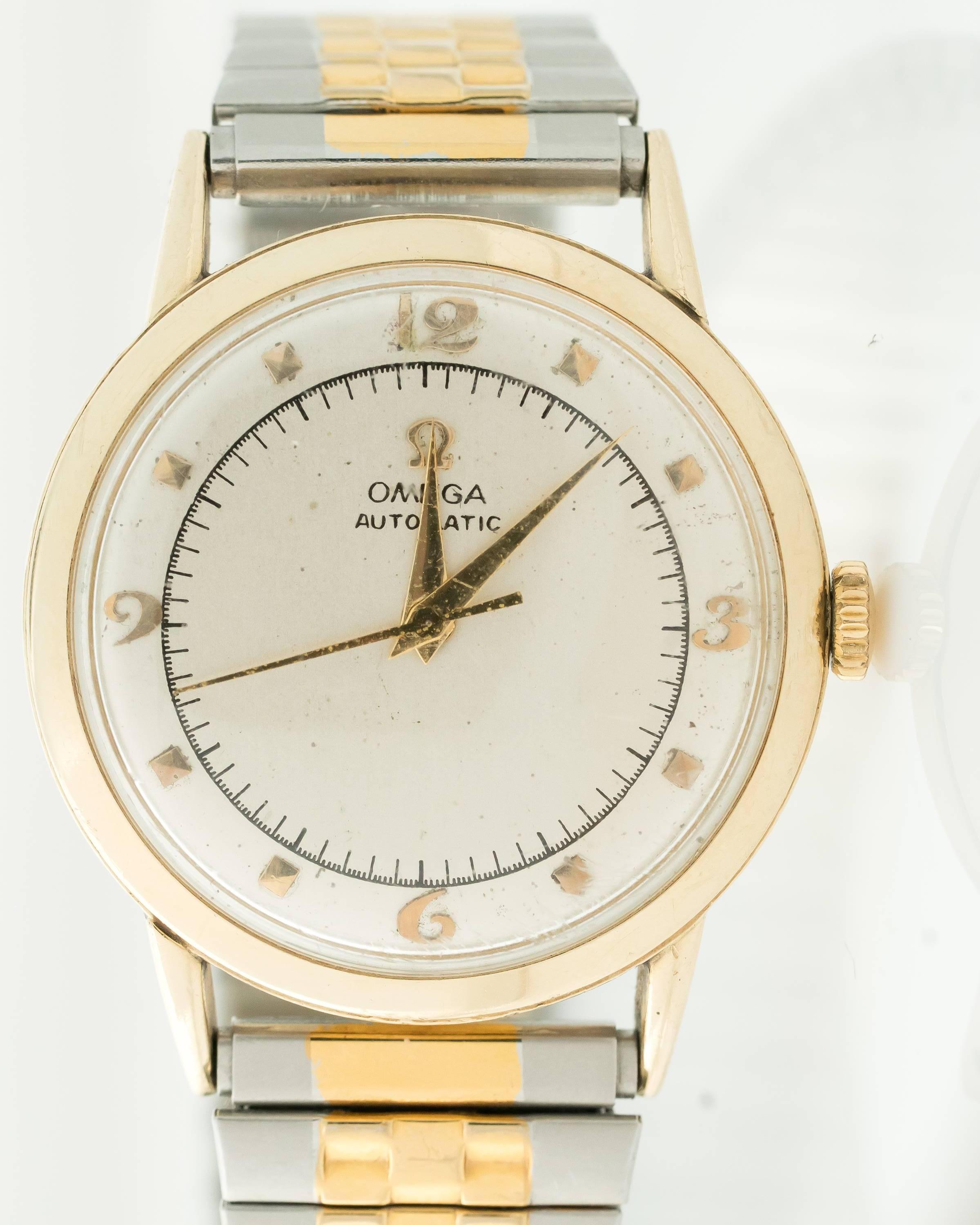 Omega wows with this 1950s classically designed 14 Karat Yellow Gold Unisex wrist watch. The round case has a smooth gold bezel and back. The satiny smooth silvered dial features gold Arabic and stick numbers, gold Alpha hour and minute hands and a