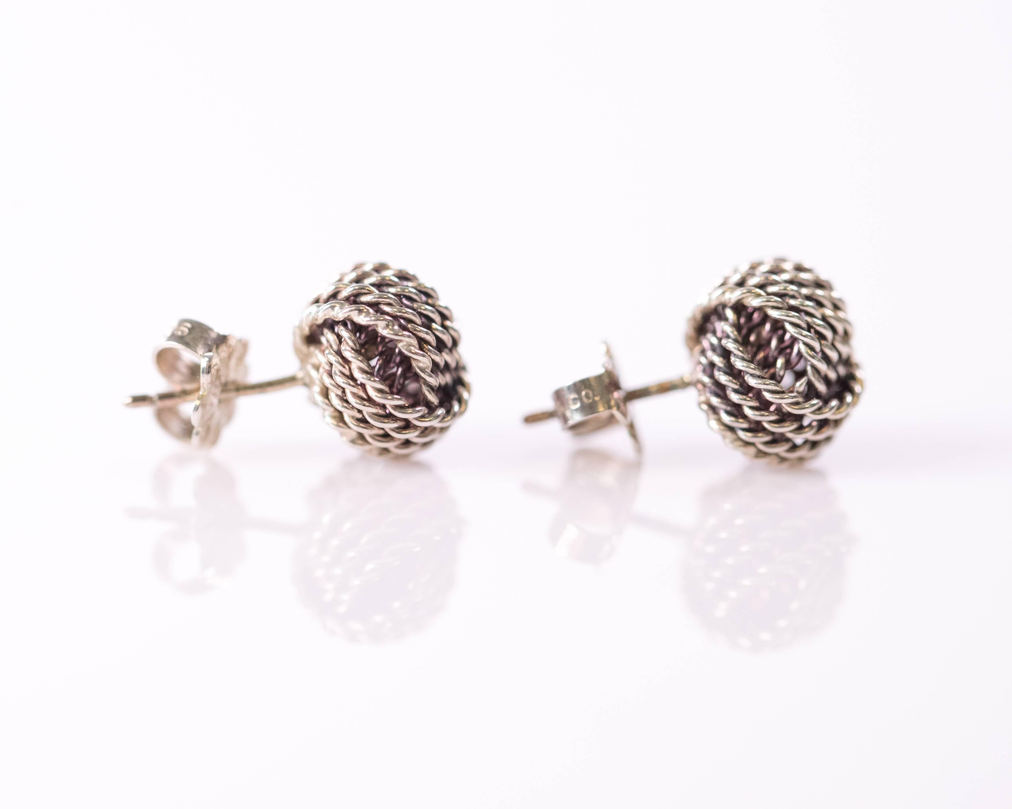 These Tiffany and Co. Sterling Silver Twist Knot Earrings are a Vintage Classic. They measure 8 millimeters across and feature 3 overlapping bundles of 4-strand twisted cable sections which combine to form a single knot.  They have push back posts
