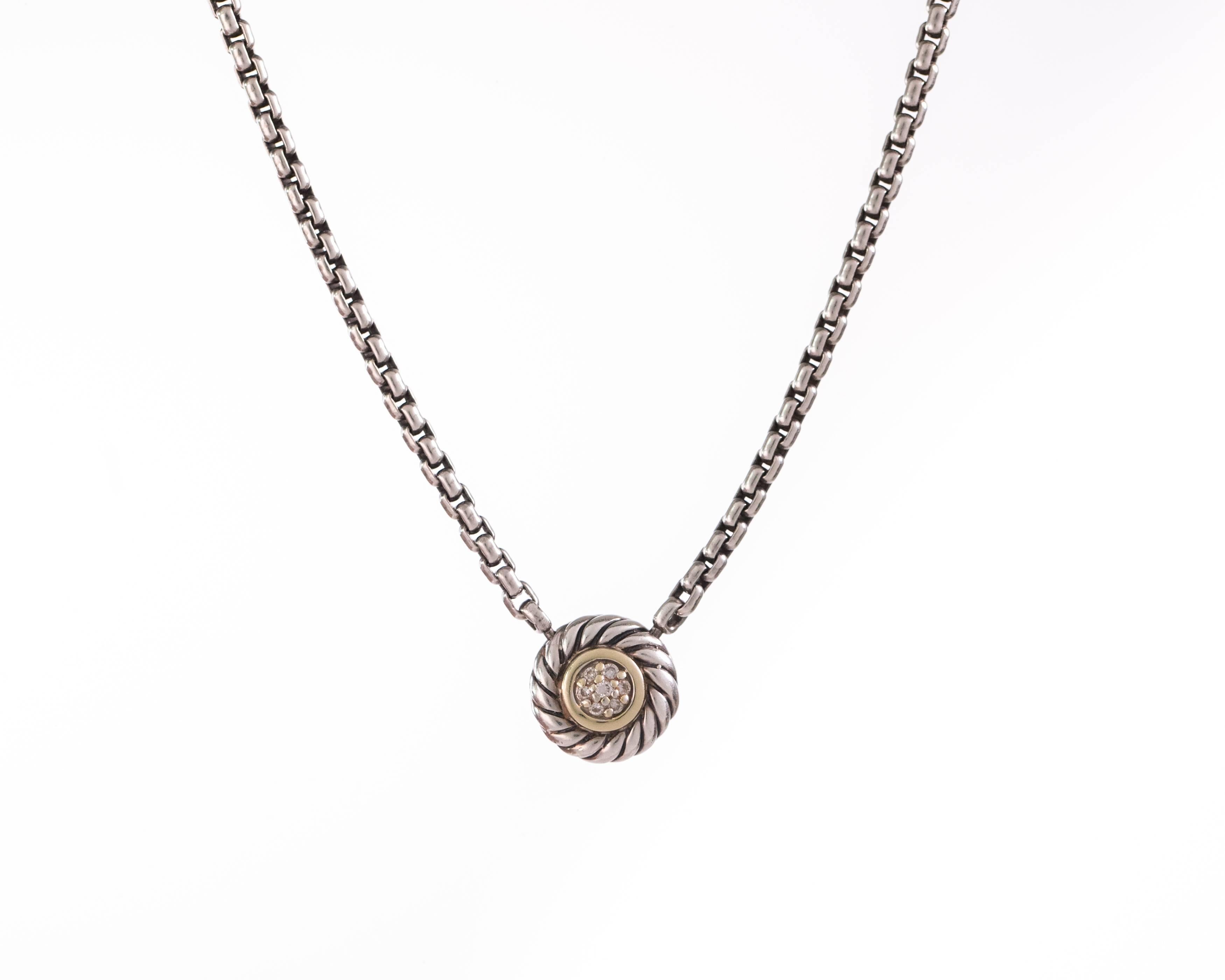 This early 2000s David Yurman 18 karat yellow gold and sterling silver Cookie pendant necklace is a classic to wear and treasure always. 

It features 0.10 carats of round brilliant diamonds, a box chain and a lobster clasp closure. It measures