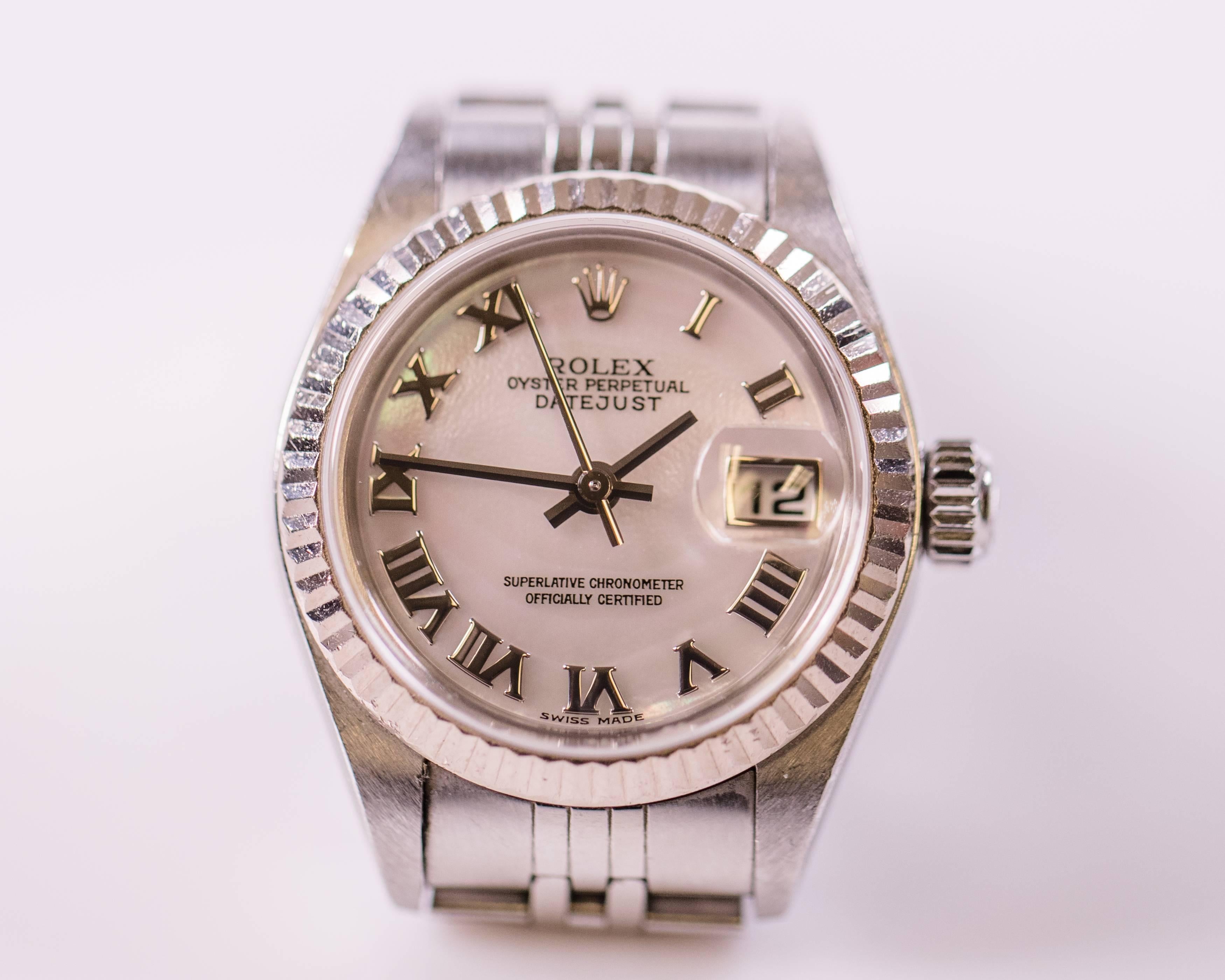 Rolex created this Elegant 18 Karat White Gold and Stainless Steel Ladies Chronometer Watch with Classic styling!
Features: 
-a Rose Mother of Pearl Dial
-Rhodium Roman Numeral Hour Markers and Stick Hands
-Date Window at the 3:00