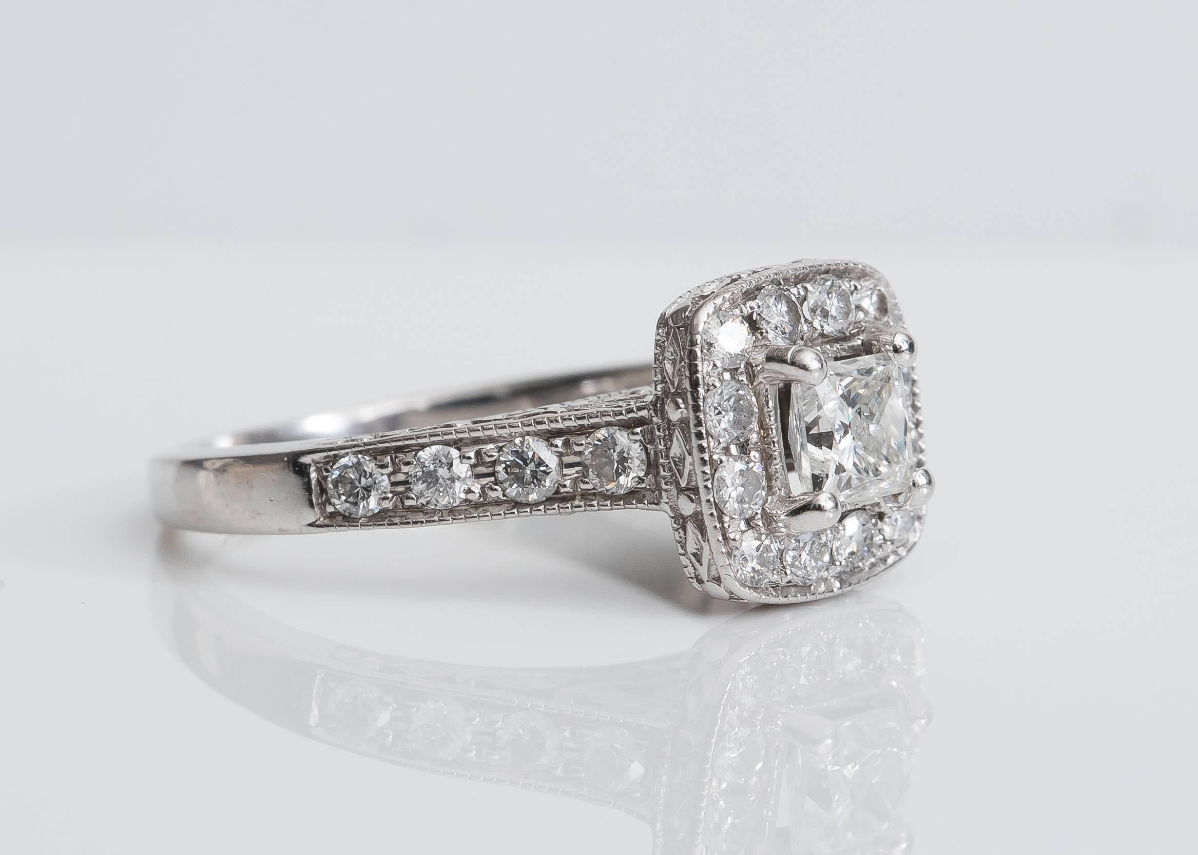 This gorgeous Diamond Engagement Ring can be custom fit to any size! 
It features a .50 Carat Princess Cut Diamond surrounded by a Diamond Halo made of round brilliant cut diamonds, set in a 14 Karat White Gold High Cathedral Mounting. The profile